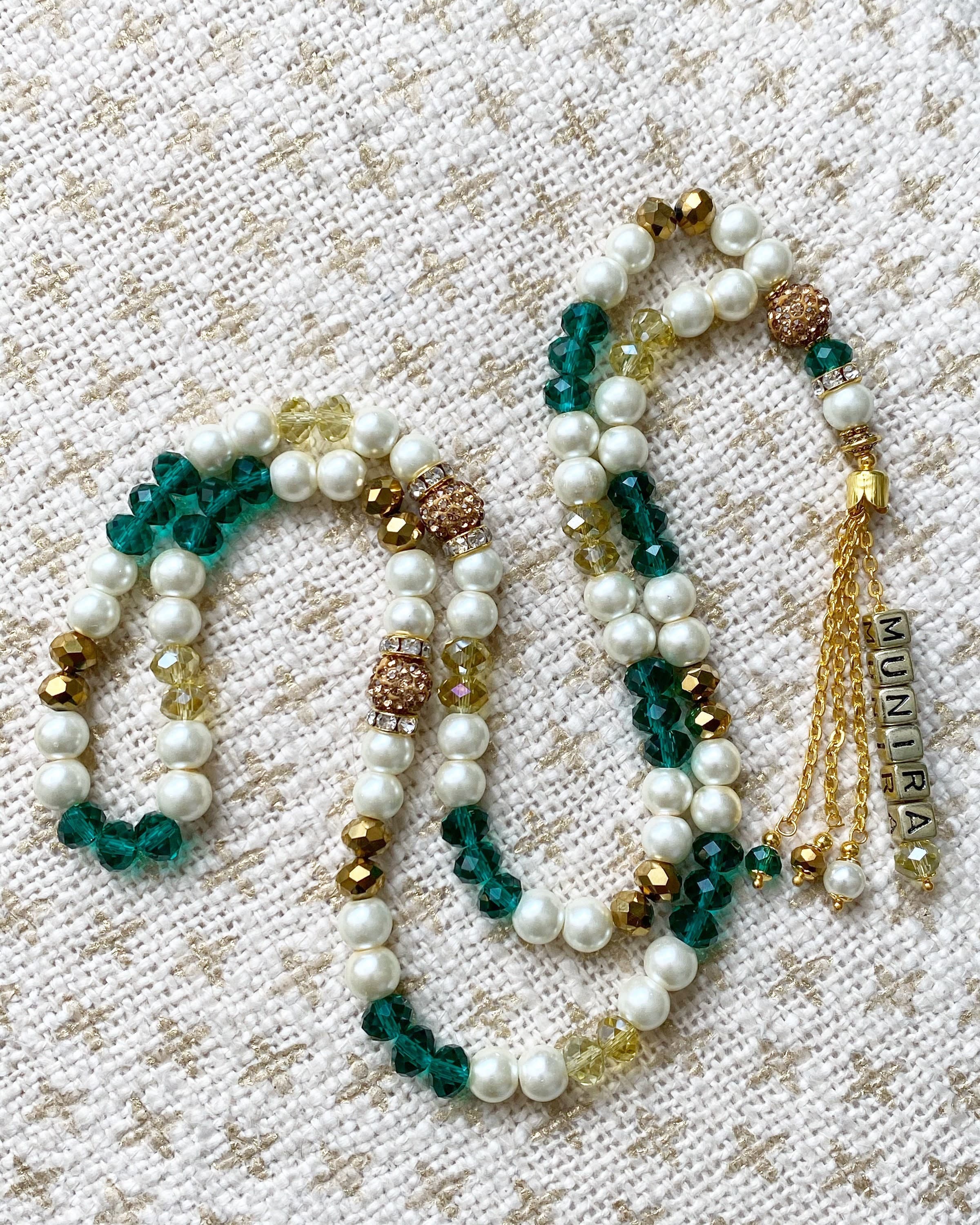 Ivory pearl tasbih with crystal beads in Emerald, yellow & metallic gold.
