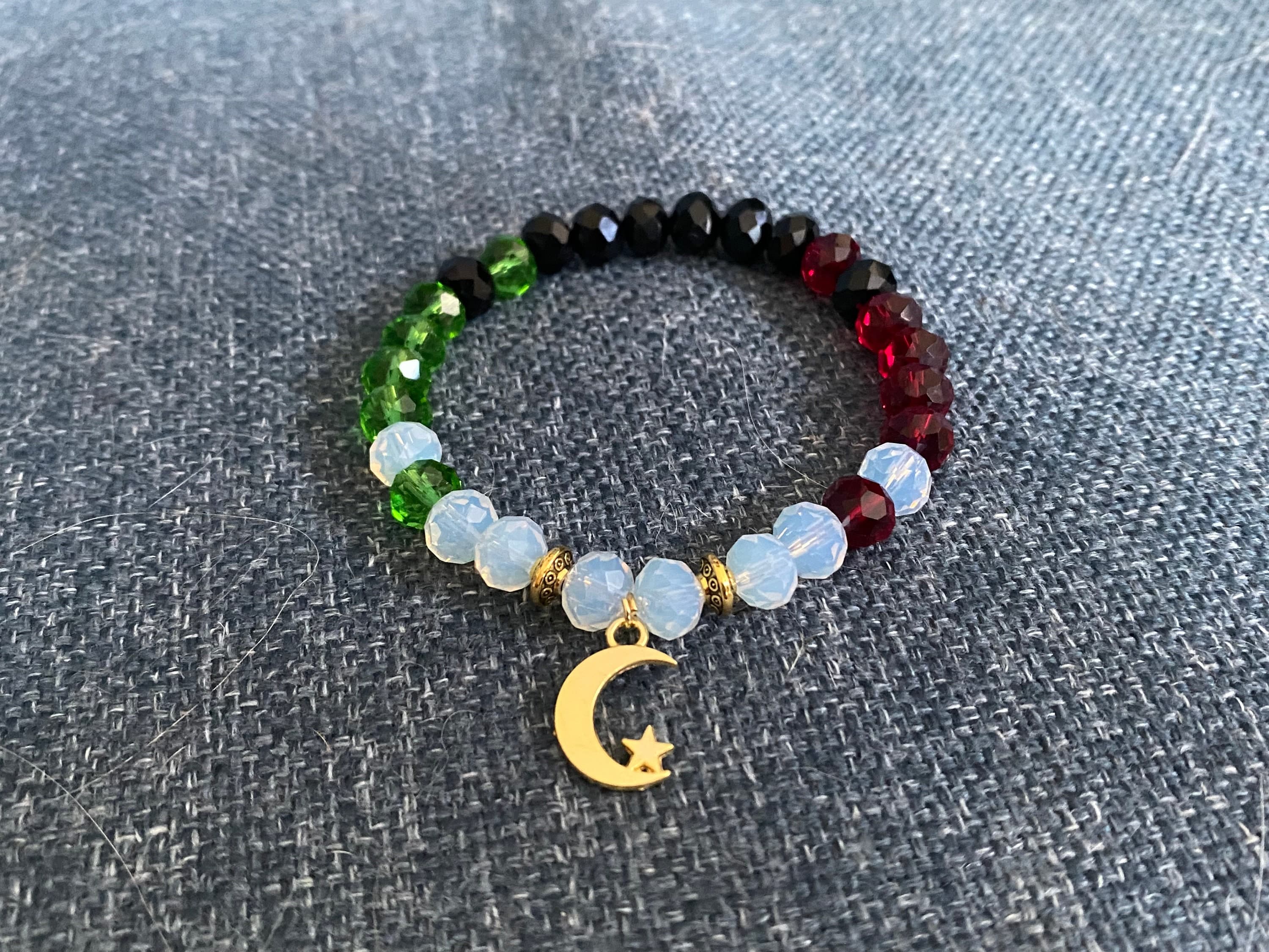 Palestine crystal bracelet with a moon pendant.