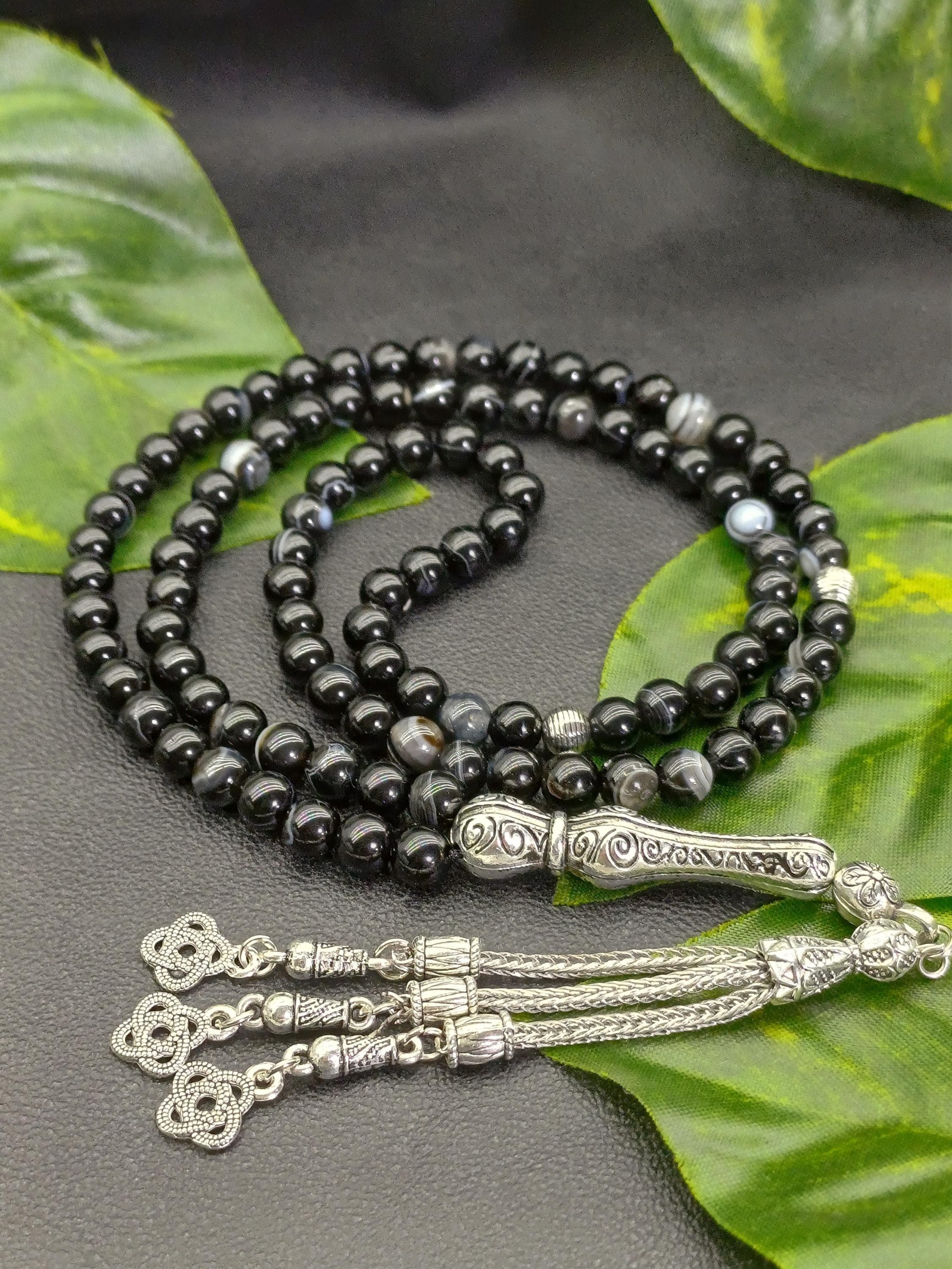 Black agate prayer beads laid flat, handcrafted 99 bead tasbih with strong thread and glossy stones