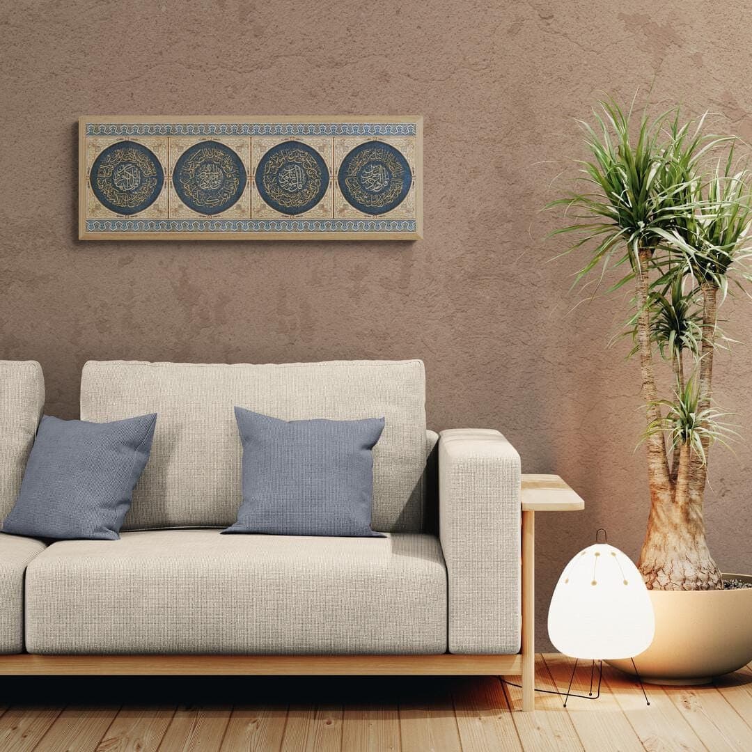 Four Qul surahs in circular calligraphy, navy background, gold script, wood‑tone frame.