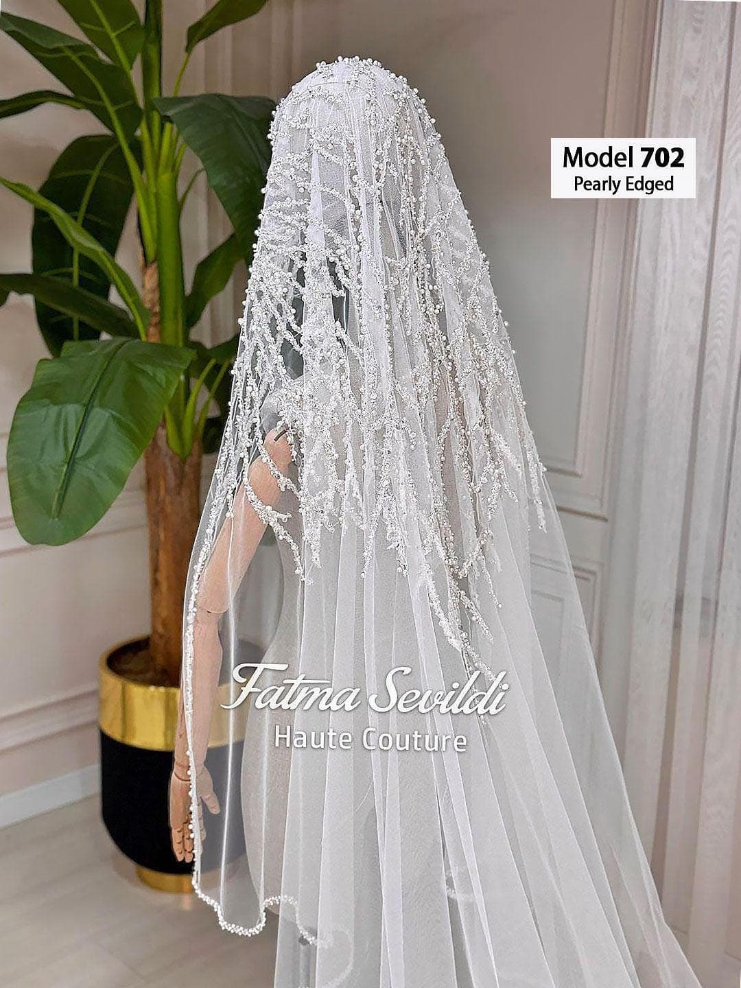 Pearl lace cathedral bridal veil in soft ivory tulle with hand-sewn beaded appliqué, designed for elegant classic and modest bridal styling. Hijab-friendly long wedding veil with refined lace detail and a timeless couture finish.
