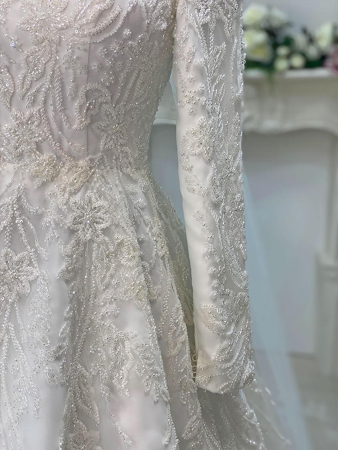 Luxury veiled hijab wedding dress with beaded lace, long sleeves, full coverage bodice, and elegant A-line bridal silhouette. Modest Muslim wedding gown with custom couture detailing and romantic lace veil.