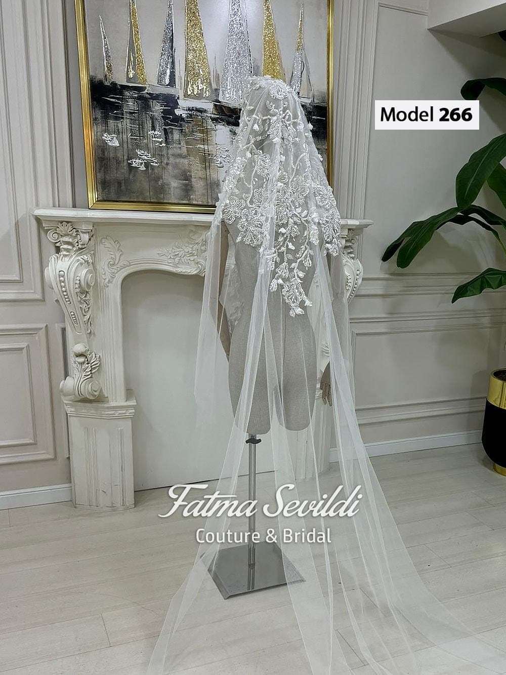 Beaded lace mantilla bridal veil in soft ivory tulle with cathedral-length drape, designed for elegant wedding styling and modest hijab-friendly wear. Long lace edge wedding veil with refined hand-finished detail and timeless bridal coverage.