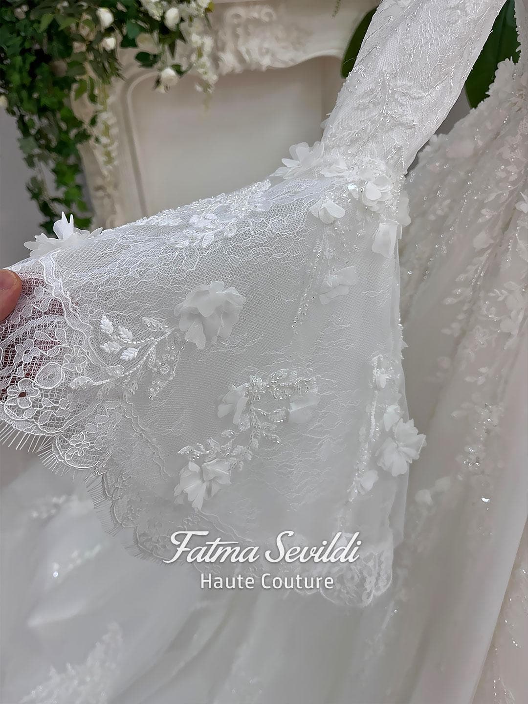 Veiled hijab wedding dress in a modest A-line silhouette with high neck, long sleeves and floral appliqué, custom made for luxury Muslim bridal coverage. Includes a matching lace veil for a complete bridal set.