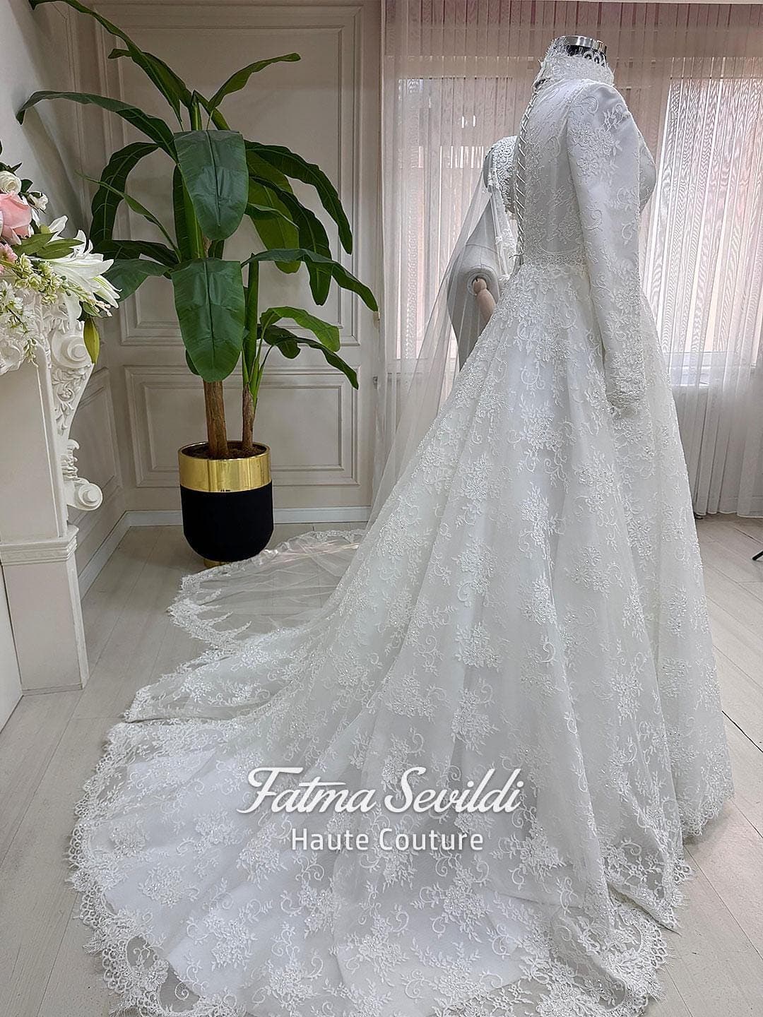 Veiled hijab wedding dress with high neck, long sleeves, and shimmering beaded lace over satin with a full skirt. Includes petticoat, headscarf, and a lace edge veil for a complete modest bridal set.