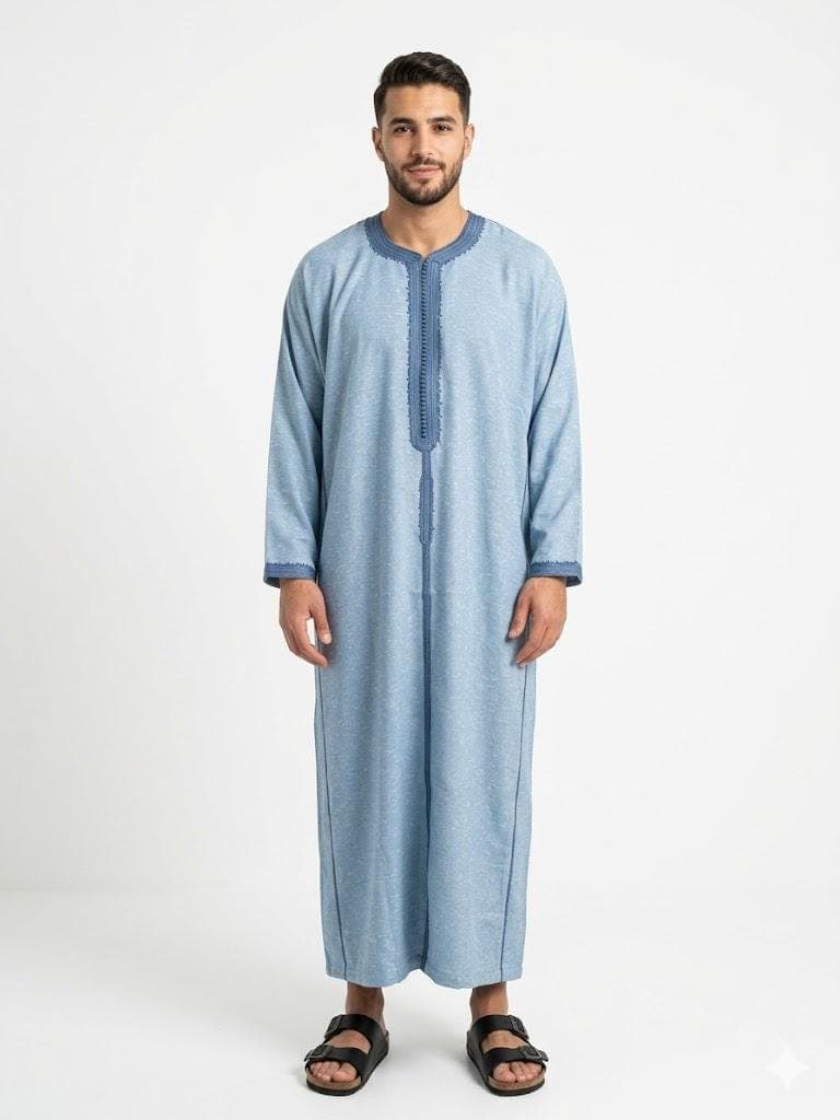 Man wearing a Light blue handmade linen Moroccan kaftan with long sleeves, standing against a plain background.