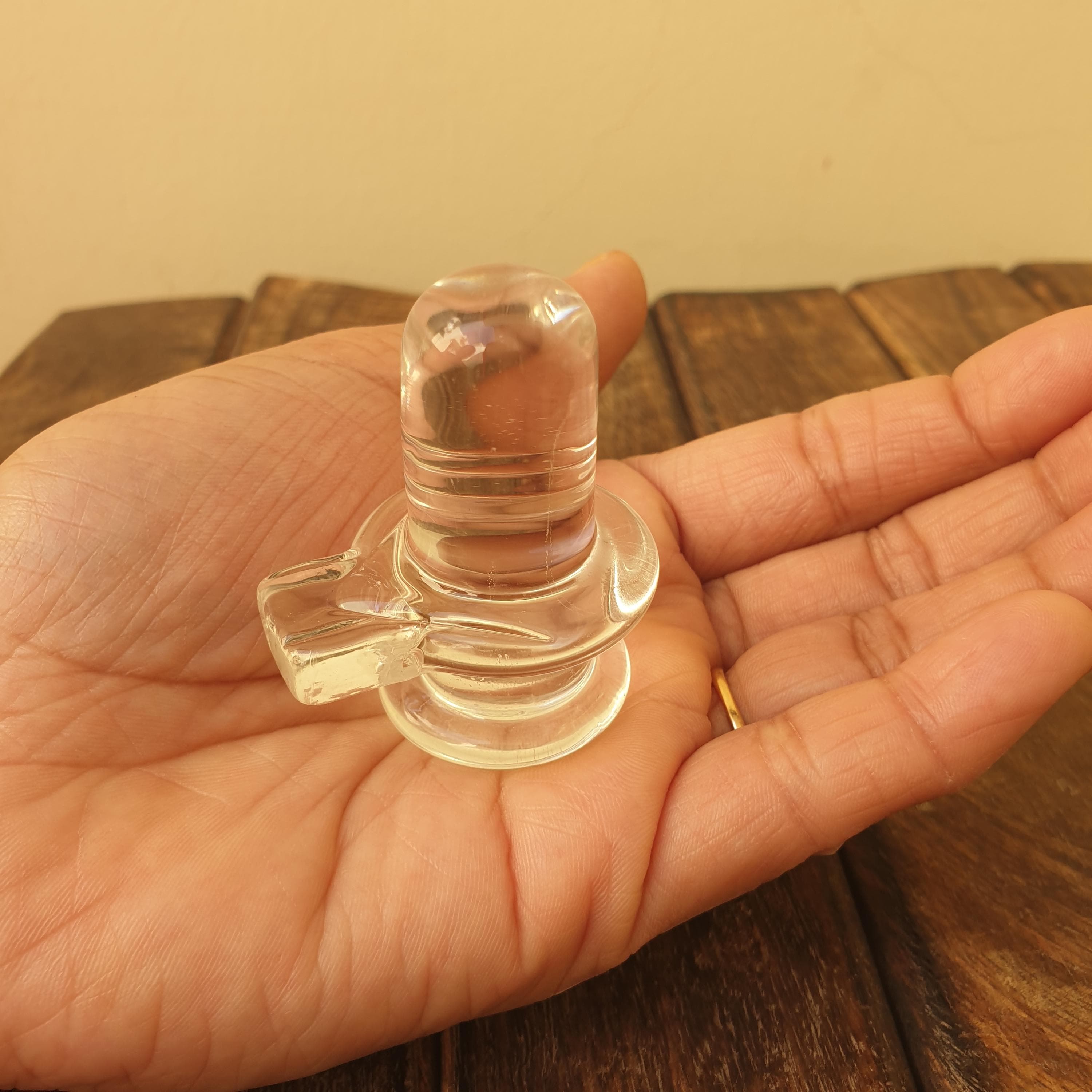 sphatik shivling,
crystal shiva lingam,
clear quartz lingam,
shiva lingam crystal,
hindu home temple,
shivling for pooja,	
 spiritual home decor,
meditation altar decor,
lord shiva idol,
 maha shivratri gift,
vastu healing crystal,
yoga room decor,
hindu religious gift