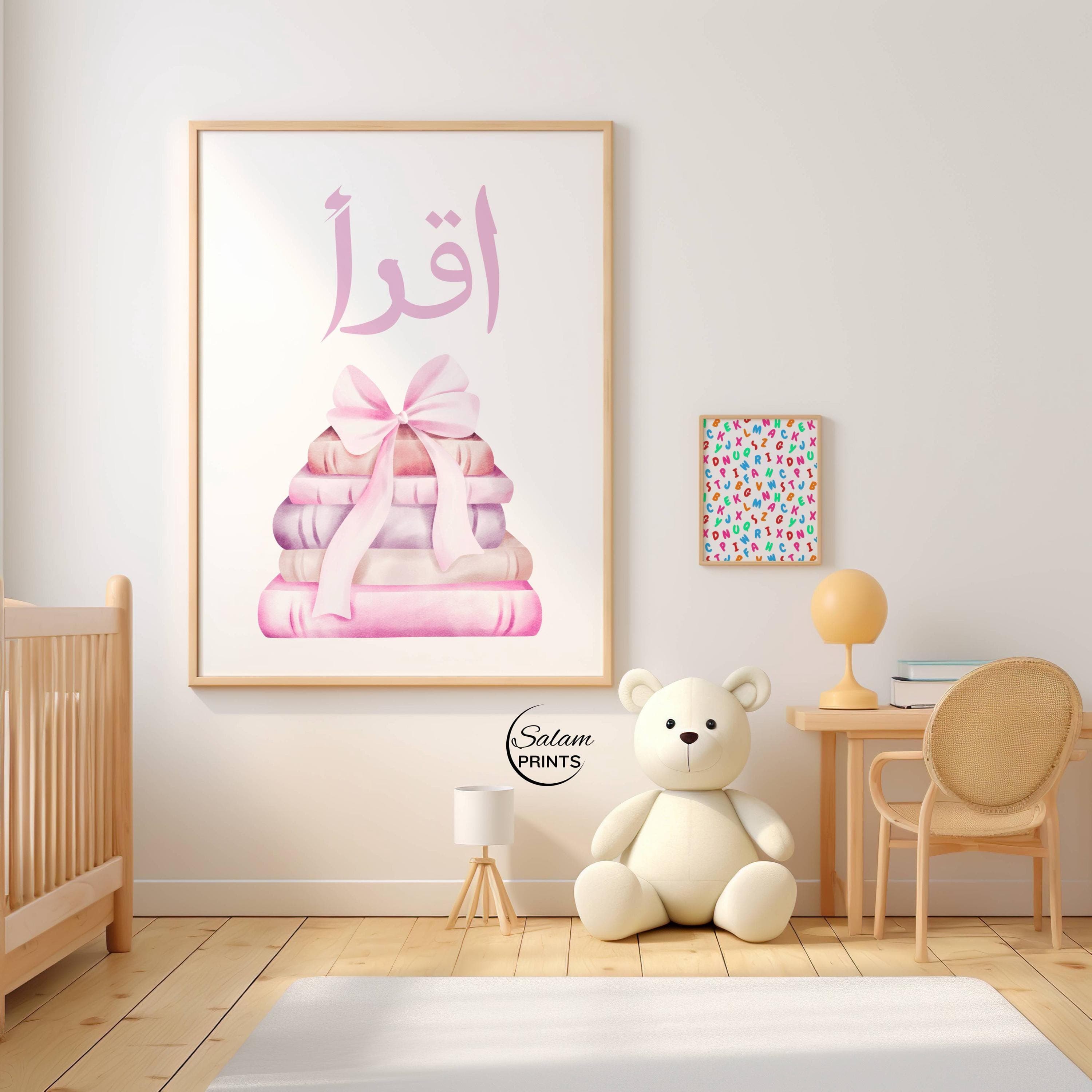 Iqra Islamic wall art printable for kids featuring soft pink bow and stacked books illustration, Quran quote “Iqra” meaning read, perfect for Muslim nursery decor, girls room wall art, Islamic learning poster for study space, baby room decoration, pastel pink nursery print, Eid gift for kids, modern minimalist Islamic home decor, digital download printable art for children’s bedroom or playroom