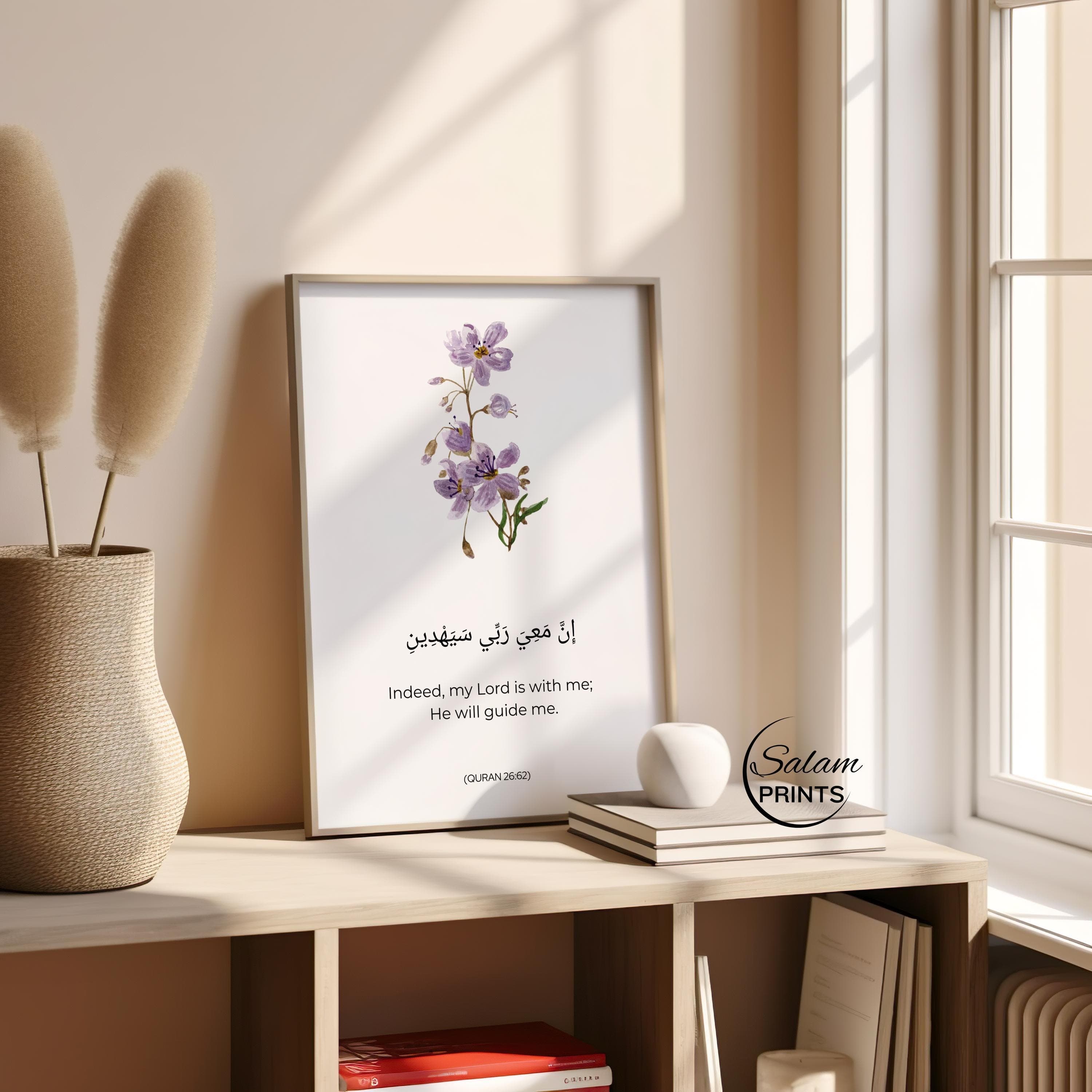 Purple colored flowers on white background with arabic calligraphy of Motivating Quran Verse 8:46 written below the floral design . Indeed My Lord is with me, He will Guide me. and below it is written its english translation .This minimalist Quranic verse print showcases the importance of Reliance on Allah in Islamic Lives. Adorned with Minimalist flower and arabic Calligraphy and english translation, This is a perfect Islamic poster for Muslim Homes.