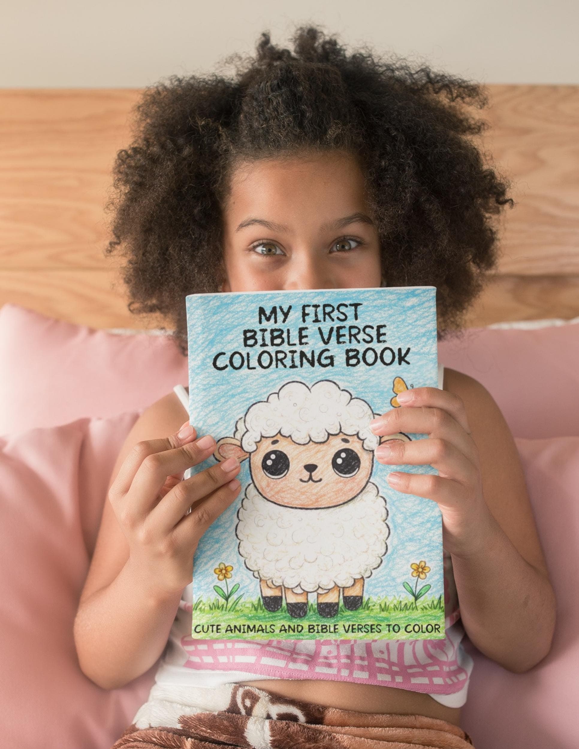 Child holding Bible coloring book for kids cute lamb cover Christian coloring book gift for children.