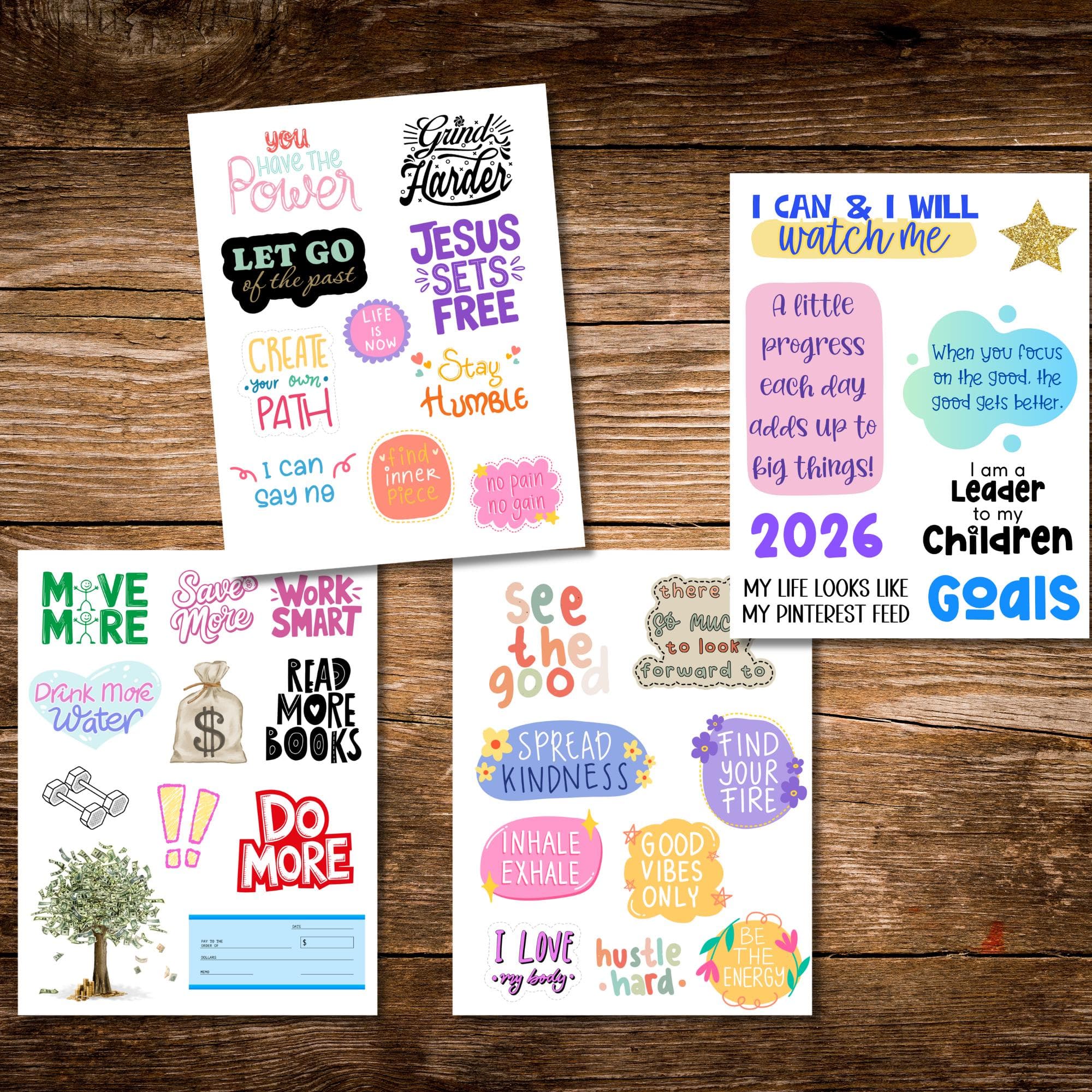 Four printable 2026 Vision Board Words sheets with colorful motivational quotes and affirmations displayed on a wooden background. Phrases include You Have the Power, Grind Harder, I Can and I Will, Good Vibes Only, Read More Books, Find Your Fire, and Spread Kindness. Perfect for vision board crafting, goal planning, and New Year inspiration.