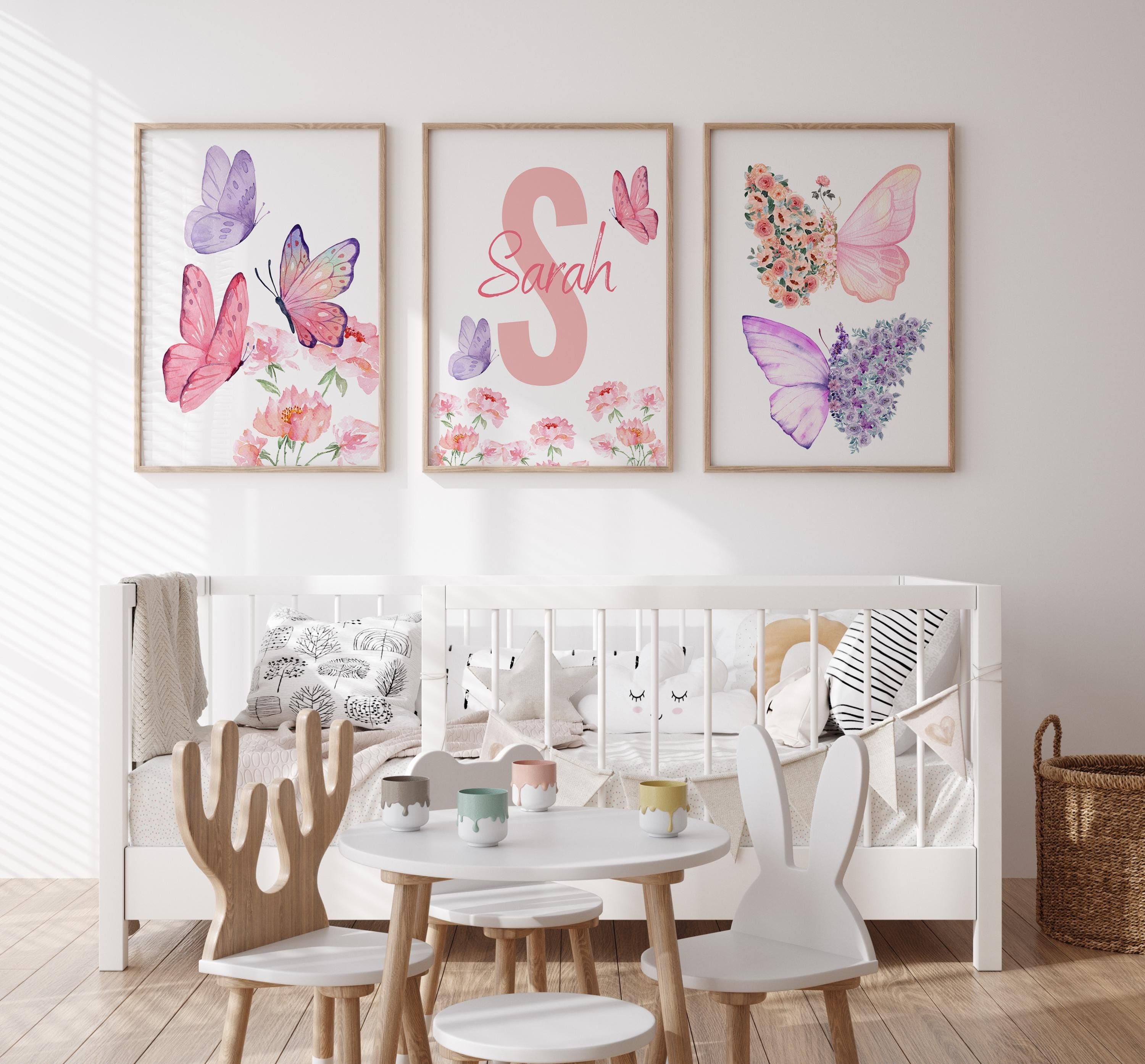 Personalized pink-themed nursery decor with floral accents.
