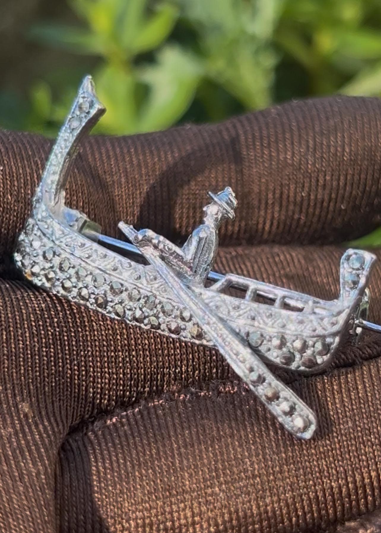 Vintage gondola brooch from the 1990s. Crafted in silver tone metal and adorned with natural marcasite stones