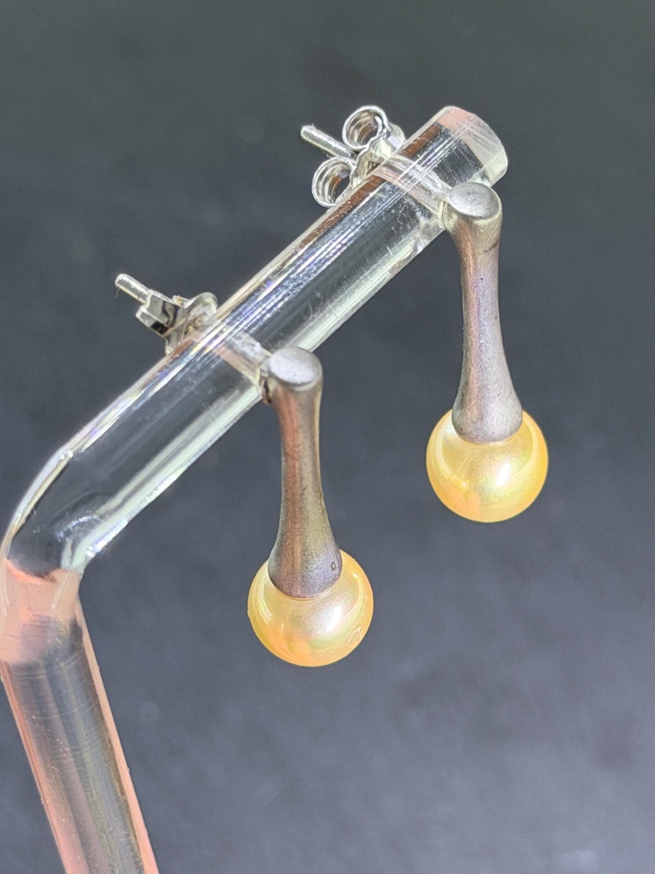 Side view showing butterfly backs and pearl sheen