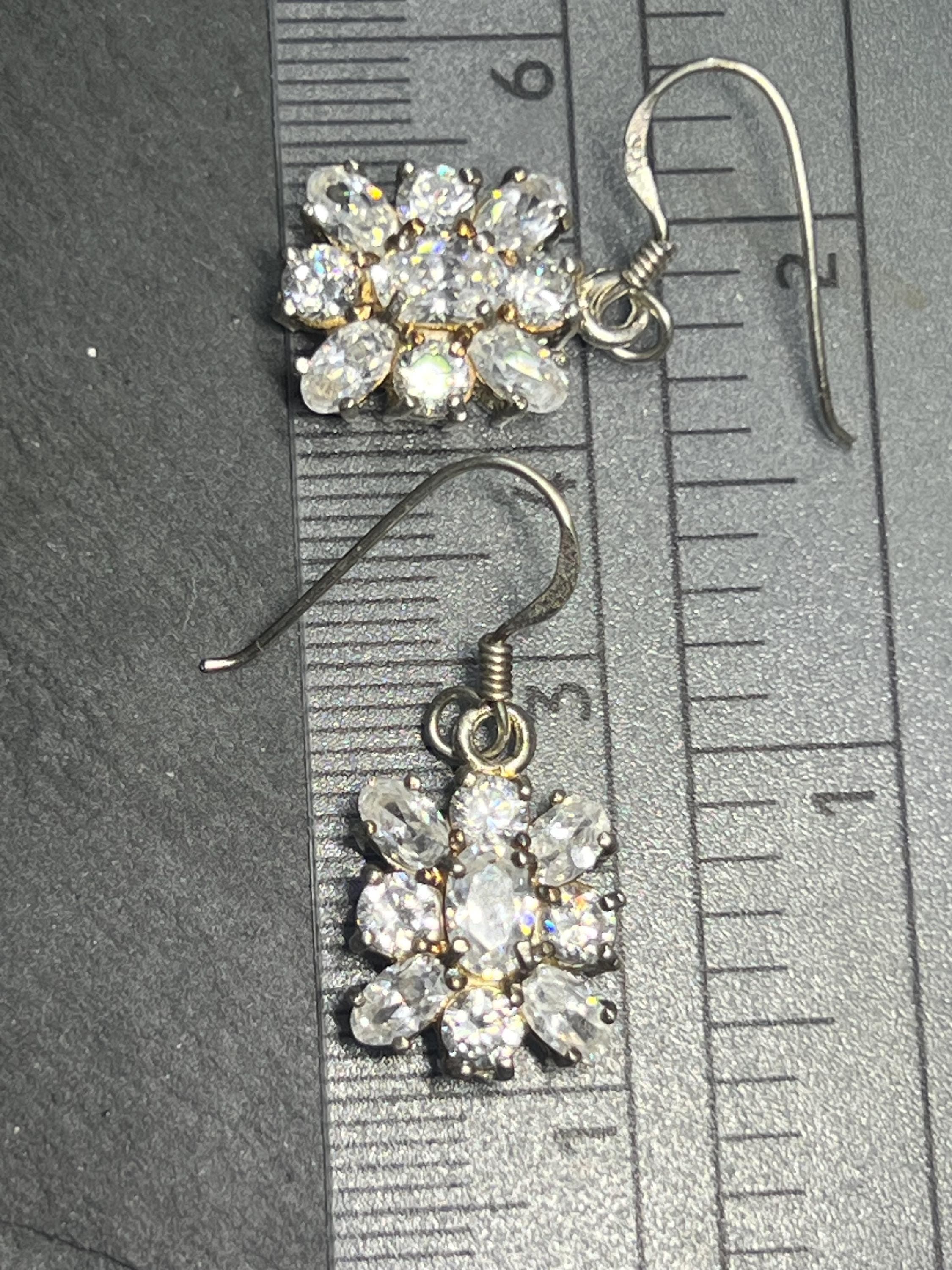 Vintage 1980 sterling silver drop earrings with floral cubic zirconia cluster design, on a ruler: 2.5 cm length