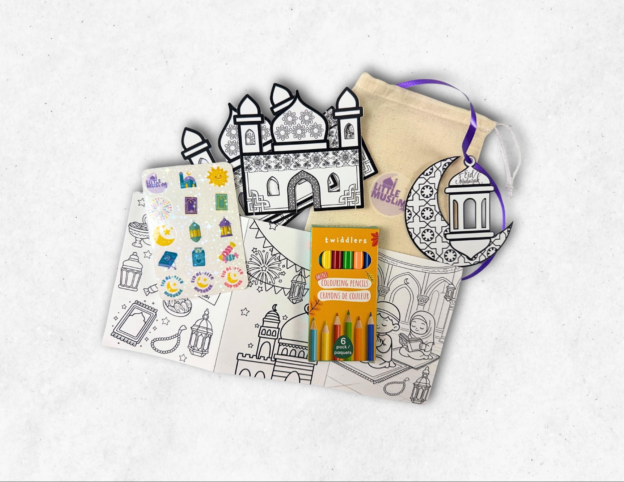 Eid activity pack for kids includes a sparkly Eid sticker sheet, DIY masjid, DIY crescent moon ornament, colouring pages, word search, maze, and information about Eid al-Fitr - all stored in a branded reusable cotton drawstring bag