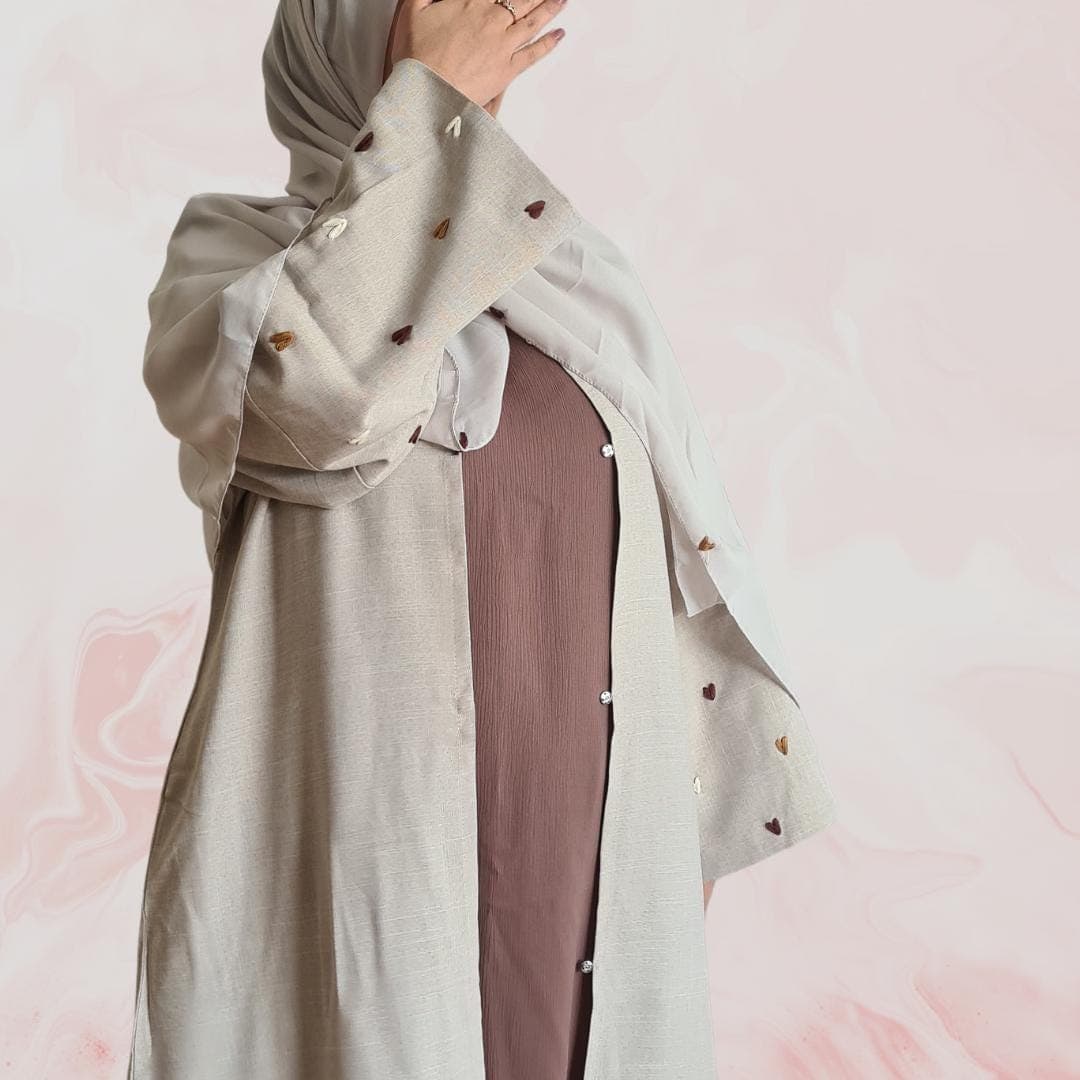 Elegant beige-grey abaya with embroidered heart designs on the sleeves, including hijab and practical pockets ā ideal for everyday wear - image 4