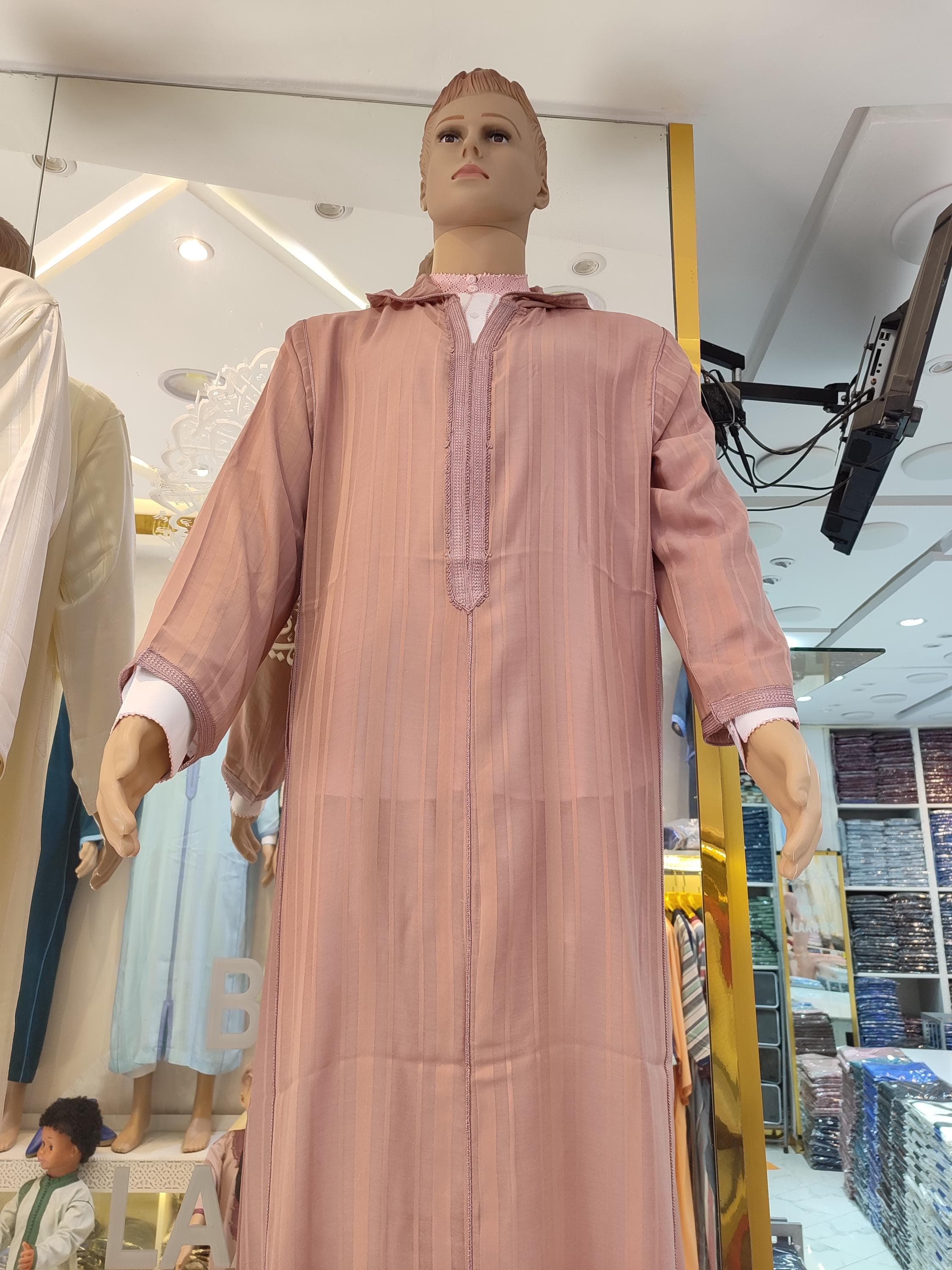Discover the elegance of this handmade Moroccan djellaba for men, crafted in the traditional sousdi style with a modern twist. This striped kaftan features a comfortable hood, flowing design, and rich fabric, ideal for Ramadan, Eid, or as a luxurious gift. A perfect blend of thobe, kaftan, and jubbah traditions, this Moroccan outfit suits any man seeking modest Islamic clothing.