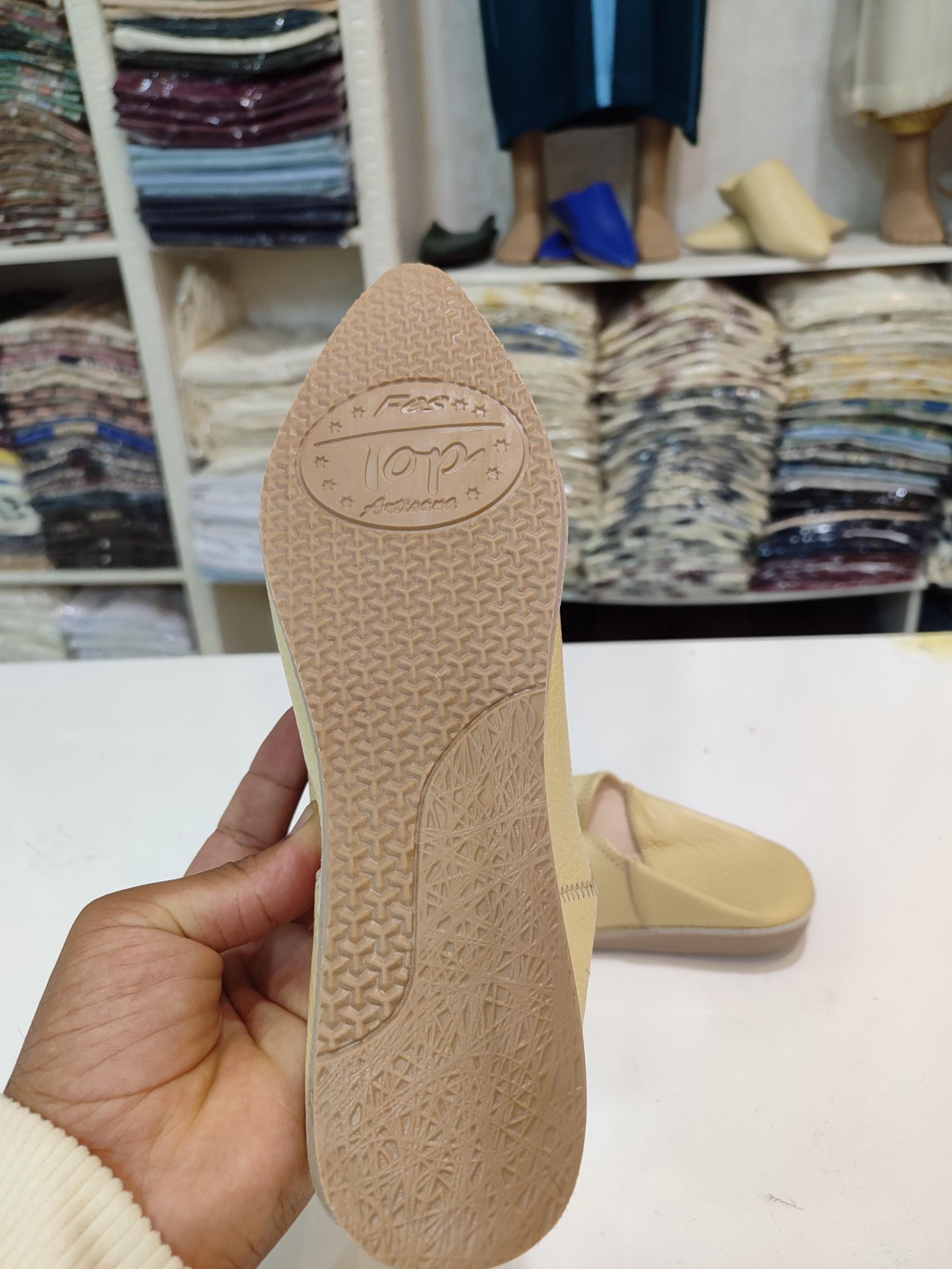 Add a touch of Moroccan elegance to your wardrobe with our cream babouche mules. Handmade from soft organic leather, these pointed toe slides are perfect for nikah ceremonies, Moroccan weddings, or everyday relaxation. The neutral beige shade pairs effortlessly with traditional henna dress outfits or modern attire, while the slip-on design ensures easy wear. Crafted with attention to detail, these Moroccan slippers offer both style and comfort. Ideal as a gift or for personal use,