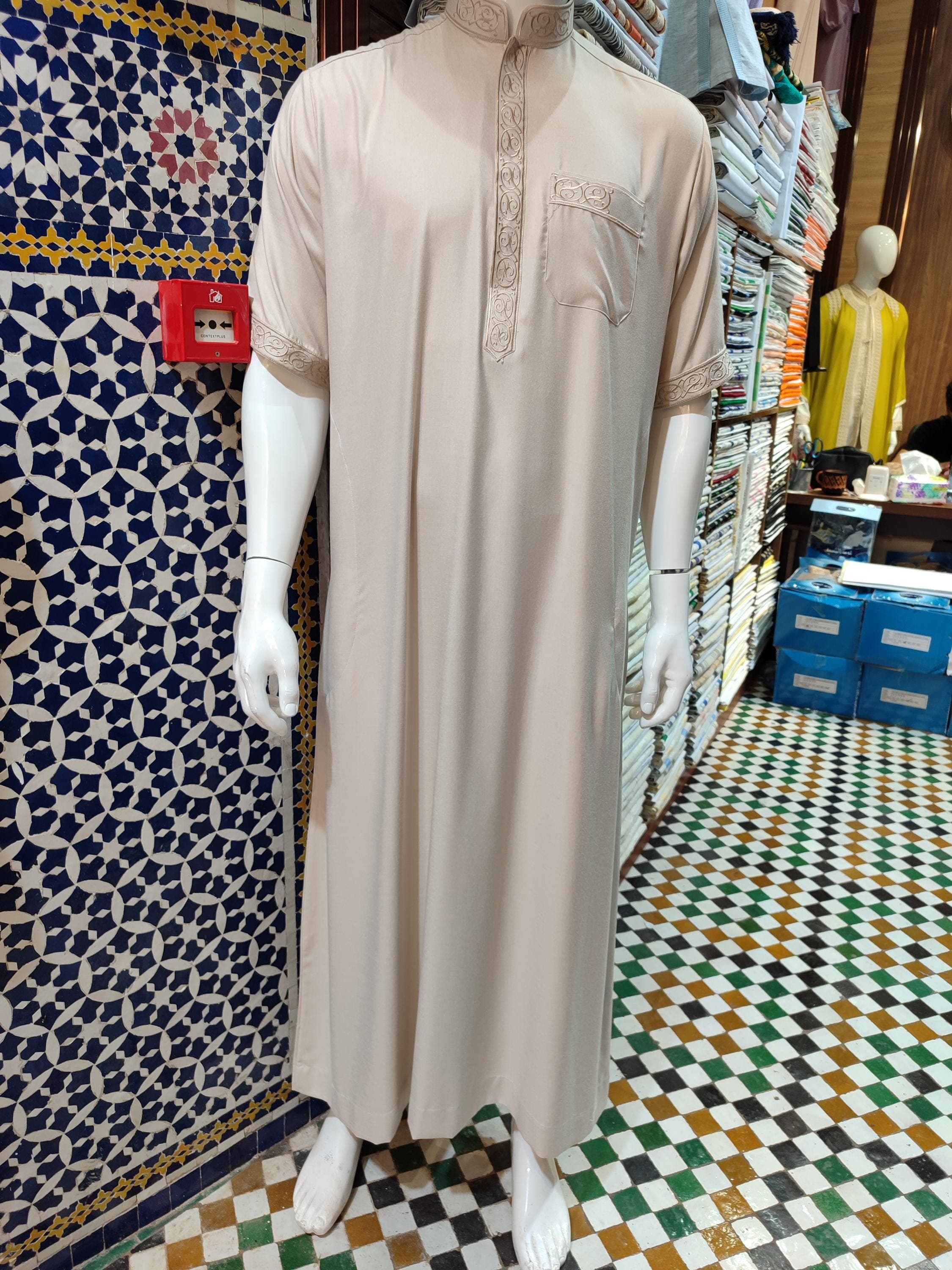 This sophisticated men thobe represents the pinnacle of Moroccan menswear tradition. Made from luxurious fabrics with intricate embroidery, this Muslim evening dress is perfect for weddings, Eid celebrations, or formal gatherings. The gandoura Moroccan design features a tailored fit with traditional accents, blending cultural heritage with contemporary fashion. The flowing silhouette and premium materials make this Palestine thobe-inspired garment both comfortable and distinguished.