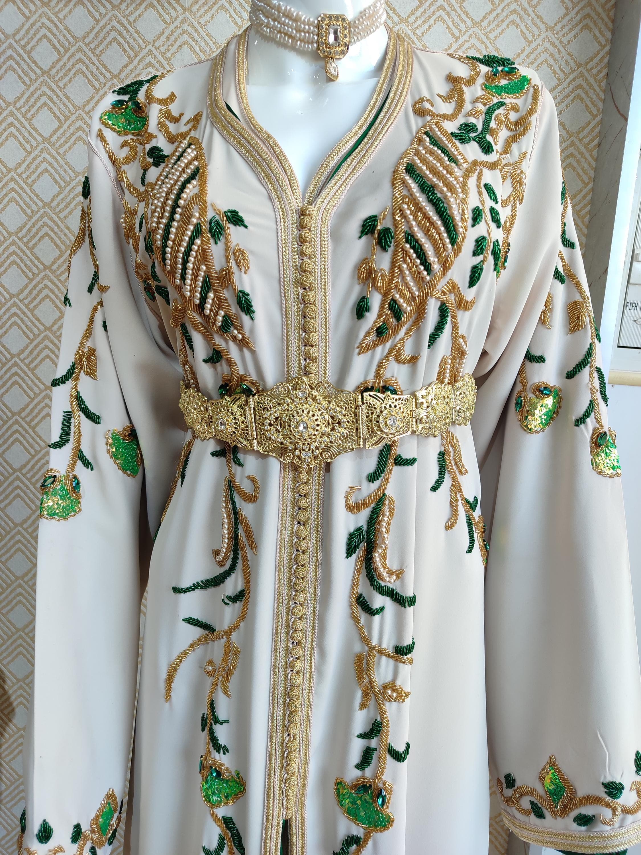 Celebrate your special day with a regal bridal thobe, merging Islamic modesty with intricate Moroccan detailing. This handmade caftan is suitable for a muslim nikah dress, adorned with beautiful tatreez and finished to perfection. A stunning mix of caftan marocain and arabic dress design, ideal for traditional and modern brides alike.