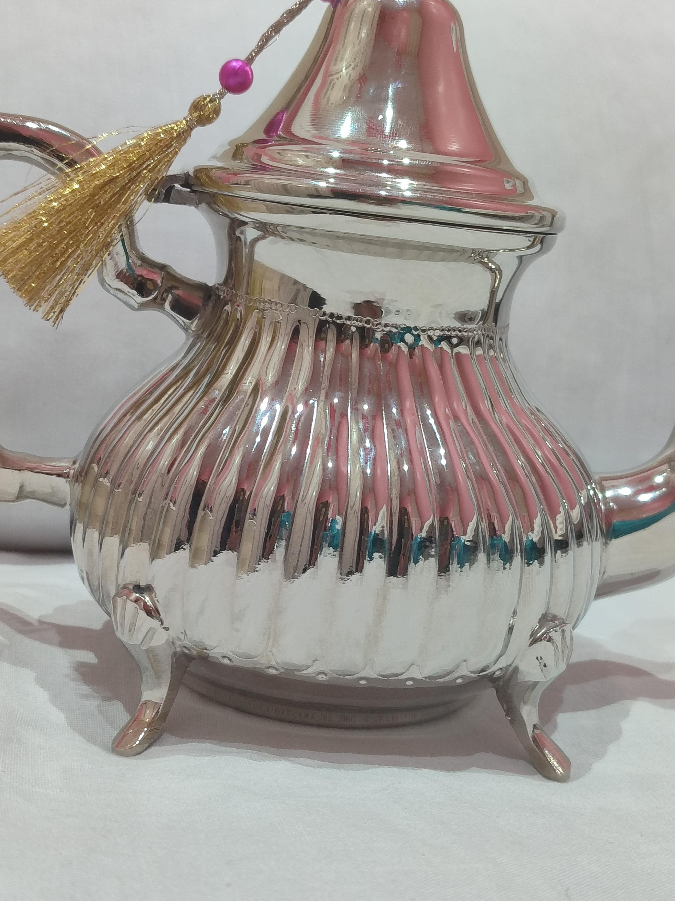 Discover this stunning artisanal teapot that captures the spirit of teapot Morocco. Crafted from high-quality silver brass, this traditional teapot features elaborate hand-engraved designs inspired by Moroccan architecture and patterns. The ergonomic handle and balanced spout make serving Moroccan mint tea a graceful experience. With its antique finish and timeless appeal, this Arabic teapot serves as both a practical tea vessel and an exquisite decorative object.