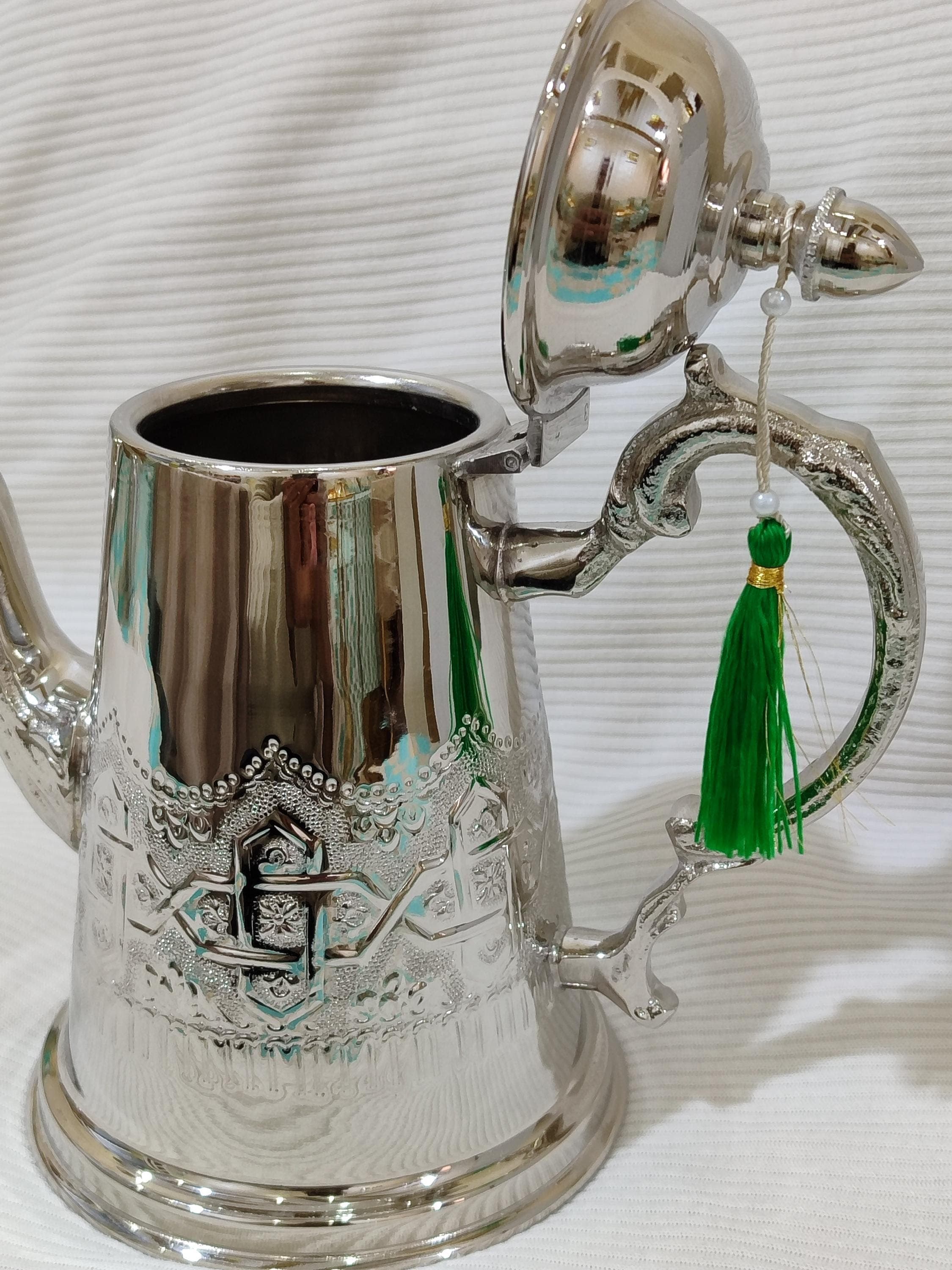 This handcrafted Moroccan tea kettle showcases the pinnacle of Islamic art and metalworking tradition. Each silver teapot is meticulously hand engraved with intricate patterns that tell stories of Moroccan culture and heritage. Perfect as a ramadan gift for those who appreciate fine craftsmanship or a memorable eid gift for tea enthusiasts, this traditional teapot elevates any tea ceremony experience.