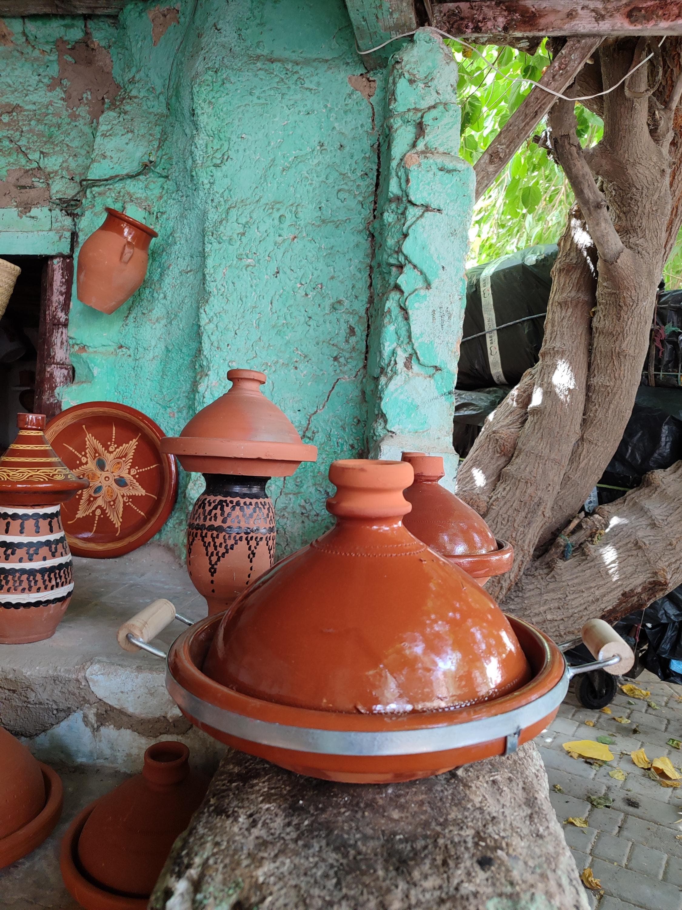 Serious cooks will appreciate this large tagine crafted from restaurant-quality clay. The extra-deep Moroccan tagine cookware holds up to 5 quarts, ideal for entertaining. Our handmade clay tagine features reinforced edges and an extra-sturdy base for daily use. The natural terracotta material ensures authentic heat distribution for perfect tajine clay cooking results every time. Includes a heat diffuser plate to protect your ceramic tagine on all cooktop types.