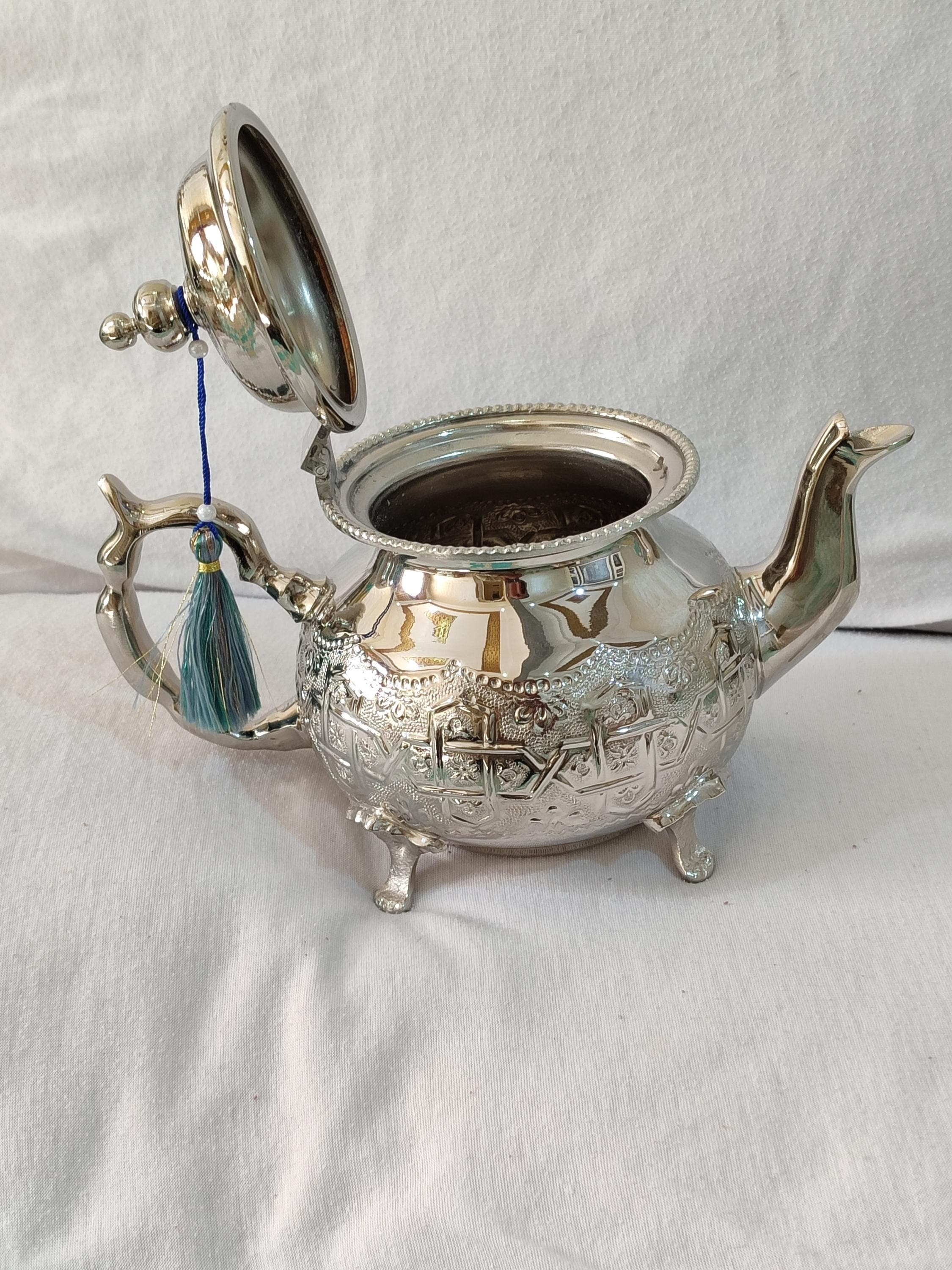 Our Berber teapot showcases authentic North African craftsmanship with its elegant silver teapot finish and traditional hammered details. The durable stainless teapot interior is lined to prevent corrosion, while the exterior displays beautiful Moroccan teapot designs. Perfect for preparing authentic Moroccan mint tea, this teapot Morocco creation features an ergonomic handle and specially designed lid to retain heat and aroma. The medium size accommodates 4-6 servings,