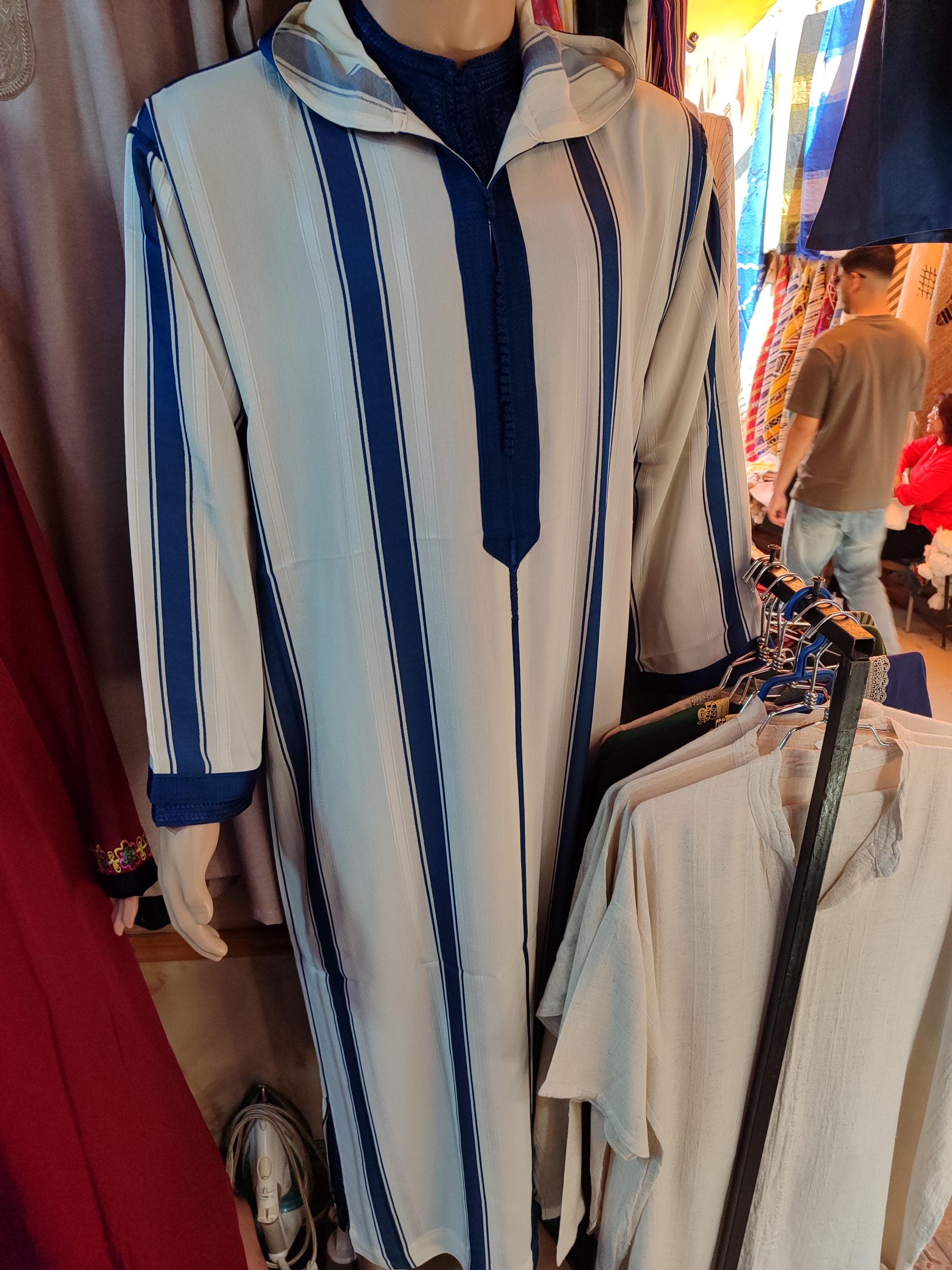 This refined kaftan for men is the perfect blend of Moroccan craftsmanship and Islamic tradition. Whether you're dressing for a nikah, Eid, or special gathering, this men's djellaba or hooded thobe for men offers a majestic and dignified appearance. Designed as a Moroccan kaftan for wedding or a thobe for men, it speaks to elegance, modesty, and heritage ideal for those who seek a long dress for men with timeless charm.