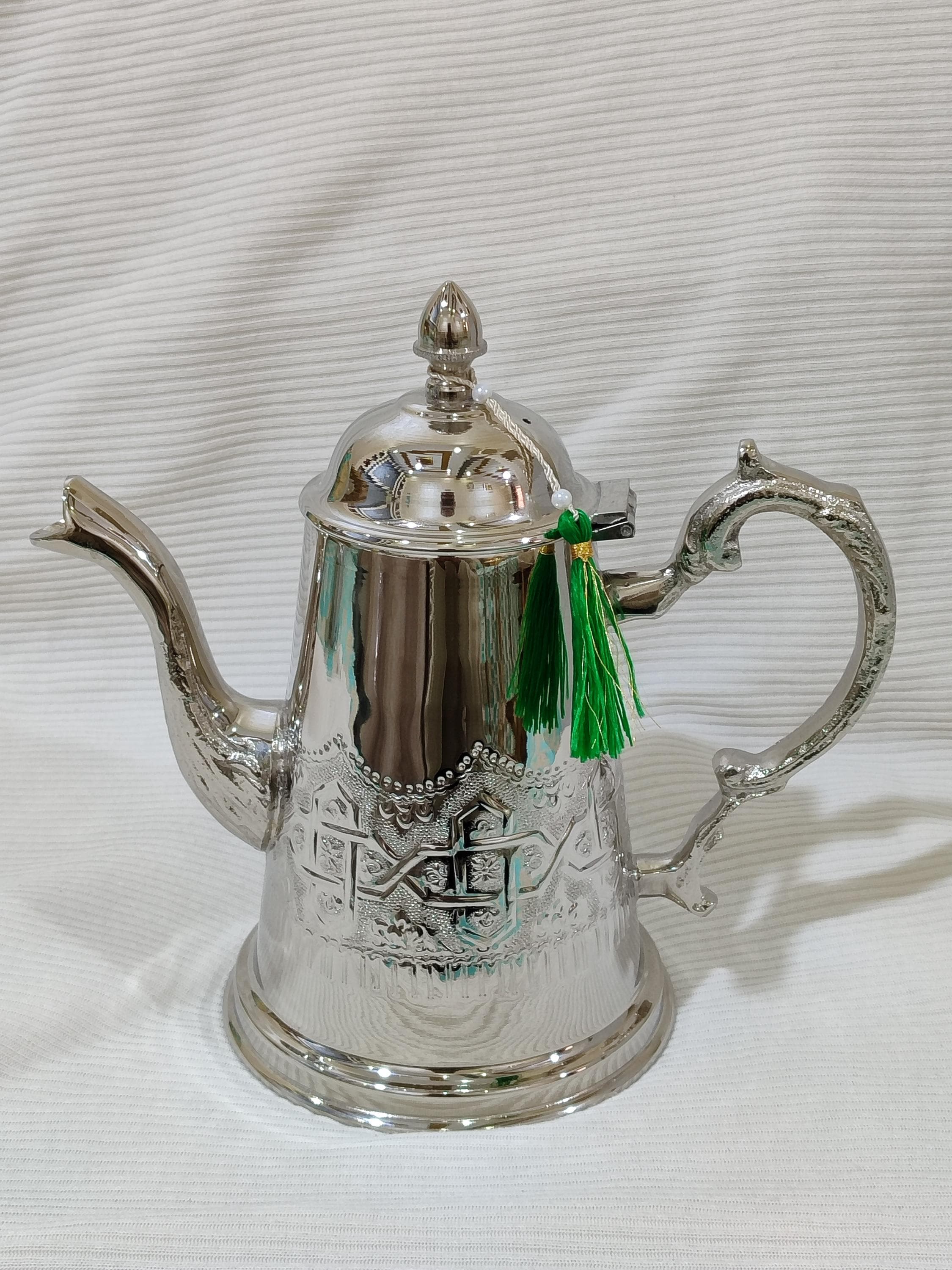 This moroccan mint tea pot set is the perfect ramadan gift for anyone who cherishes the tradition of sharing tea with loved ones. The silver teapot features stunning hand engraved details that reflect centuries of Moroccan artistry. Complete with matching tea glasses, this set is ideal for tea ceremony celebrations during eid and ramadan gatherings. As a piece of islamic art, it represents the beauty and hospitality that define Moroccan culture.