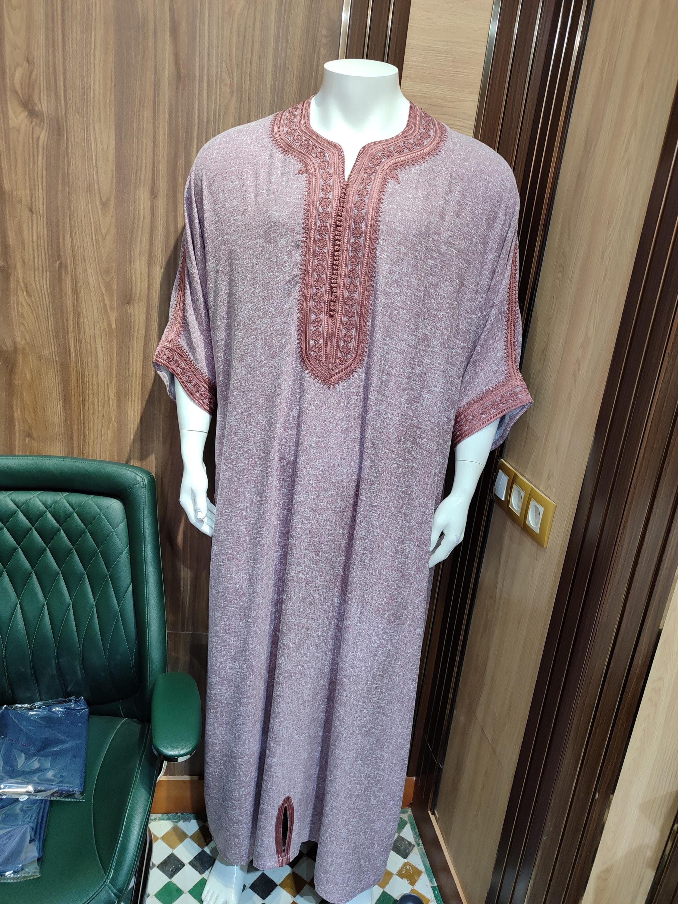 Experience ultimate comfort in this Moroccan menswear masterpiece. The kandoura cubbe is hand-sewn from premium cotton blend fabric, featuring the classic thobe silhouette with a modern twist. This Arabic dress showcases intricate geometric patterns along the chest and sleeves, reflecting authentic Islamic cloth traditions. The loose jubba cut ensures freedom of movement while maintaining an elegant drape. Ideal for warm climates, this breathable Muslim long kurta