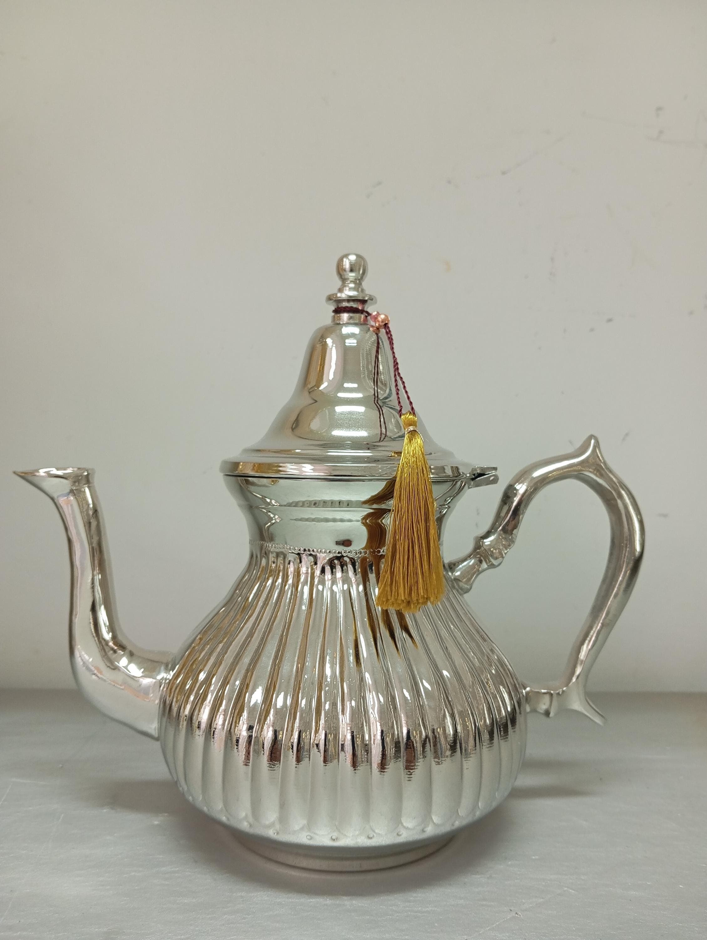 Crafted for tea enthusiasts, this iron teapot offers durability and timeless beauty. Its handmade teapot design fits perfectly in a kettle tea set, making it ideal for serving with an antique brass tray. Whether steeping loose-leaf tea or using a tea steeper, this artistic tea pot enhances every sip.