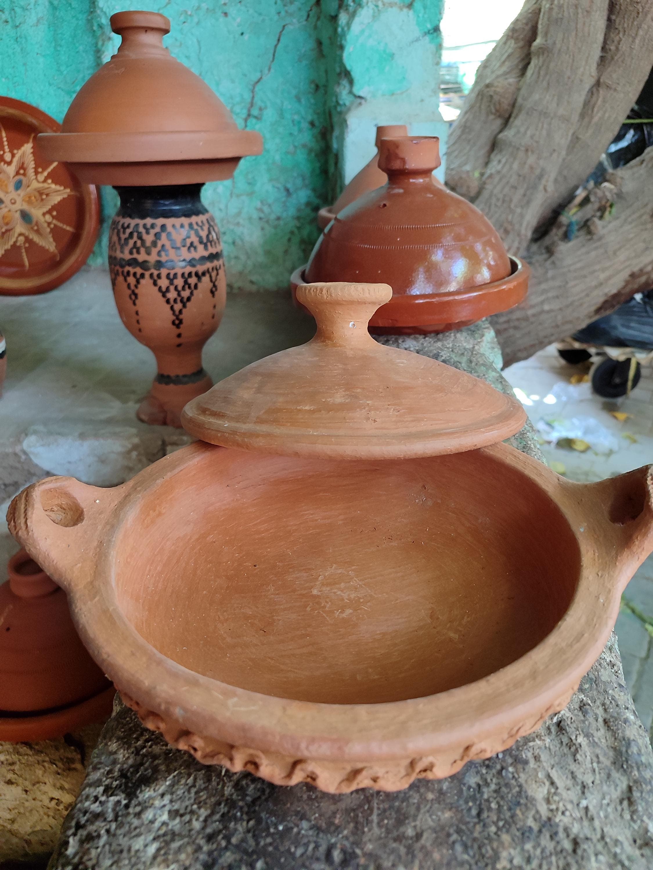 This classic tajine represents authentic Moroccan cookware at its finest. Expertly crafted from high-quality clay, it's designed specifically for tagine cooking methods. The glazed exterior features traditional Moroccan ceramic designs, while the unglazed interior improves with each use. Perfect for creating aromatic Moroccan dishes with complex flavors. The tajine clay construction is both durable and beautiful, suitable for cooking and table presentation.