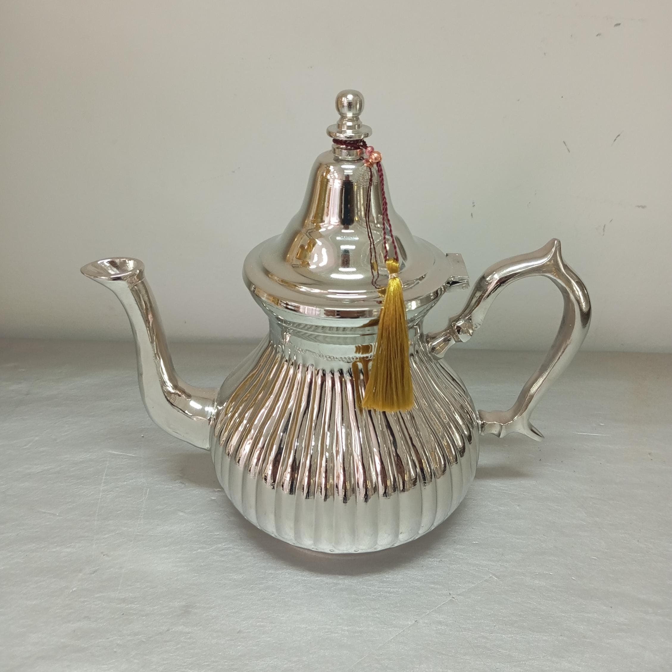 This silver-plated teapot blends craftsmanship with tradition, making it an essential part of any Moroccan tea set. Designed for both aesthetic and practical use, this large teapot enhances your tea rituals. Whether paired with a tea kettle or a tea steeper, this unique tea pot adds a touch of authenticity to every pour.