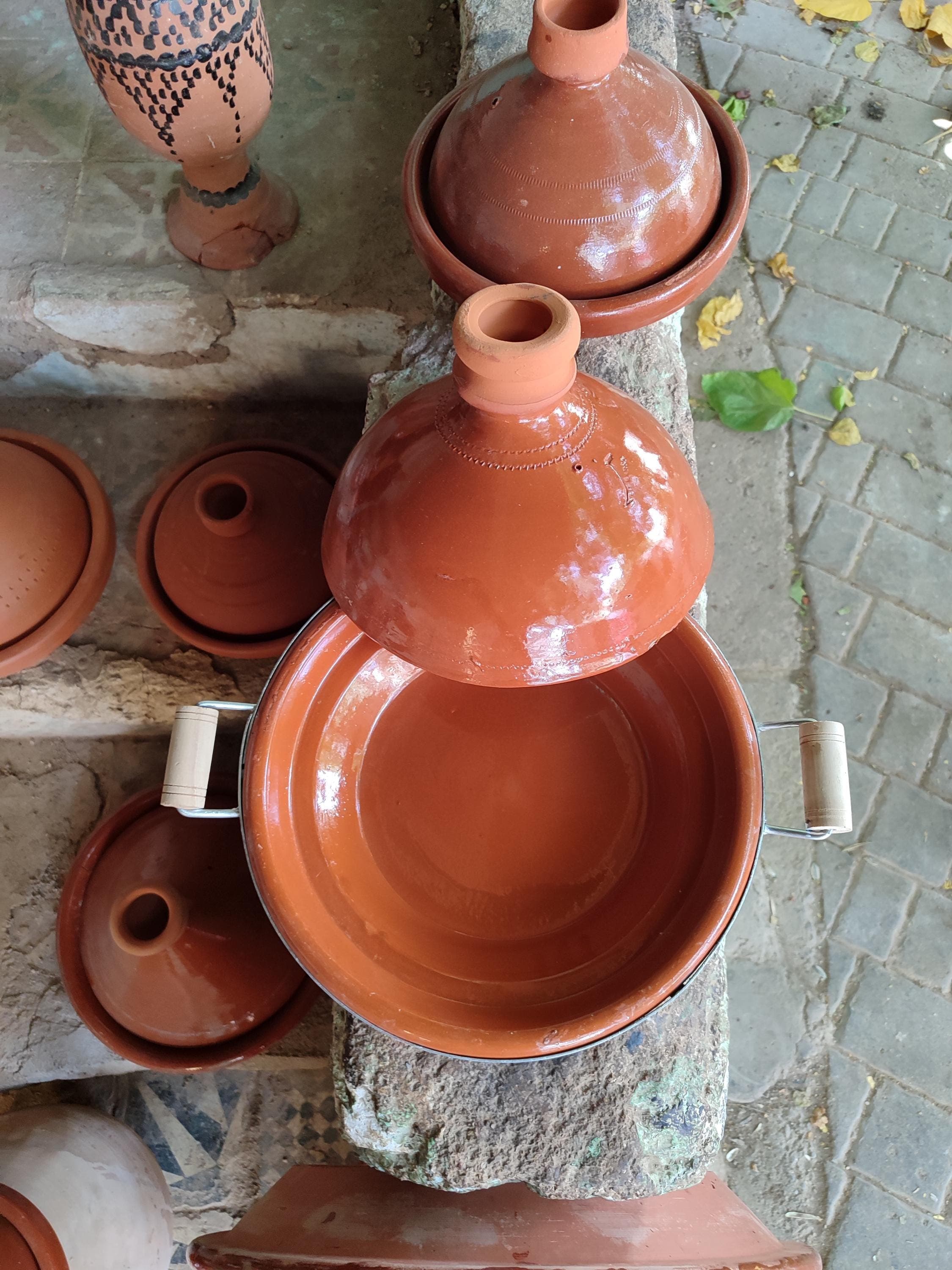 Our antique tagine design replicates traditional 19th century Moroccan cookware with modern durability. The large ceramic tagine (13" diameter) features a wider base for cooking complete meals. The terracotta construction provides superior heat retention compared to metal pots. Perfect for preparing classic Moroccan tajine dishes like lamb with prunes or vegetable couscous. The unglazed interior naturally, while the glazed exterior makes this tagine pot for cooking easy to clean.