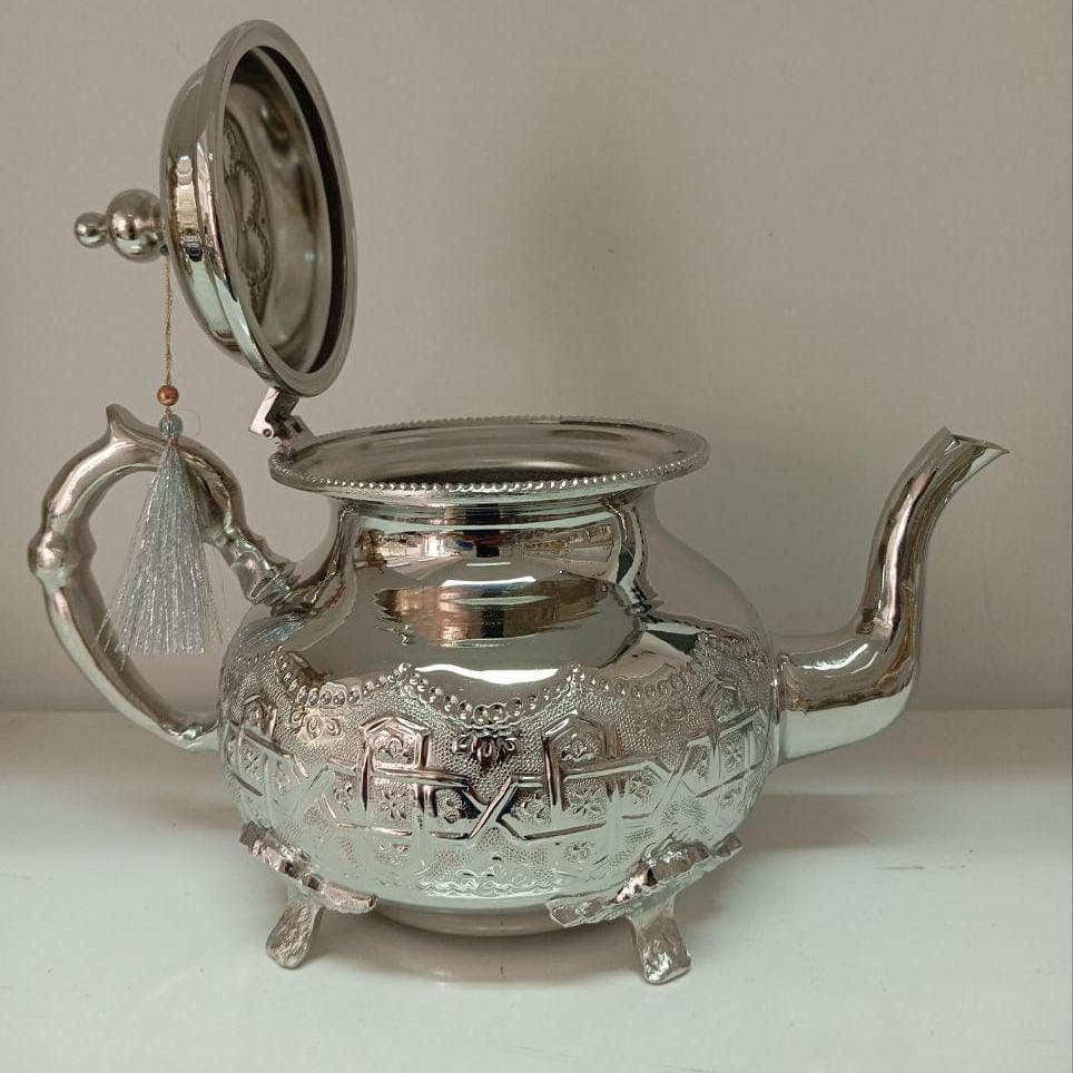 This silver plated teapot is a perfect blend of elegance and tradition, crafted for tea lovers who appreciate quality. Designed as part of a Moroccan tea set, it pairs beautifully with handmade Moroccan tea glasses and an antique brass tray. Whether steeping tea with a tea steeper or pouring directly, this handmade teapot elevates every tea-drinking experience.