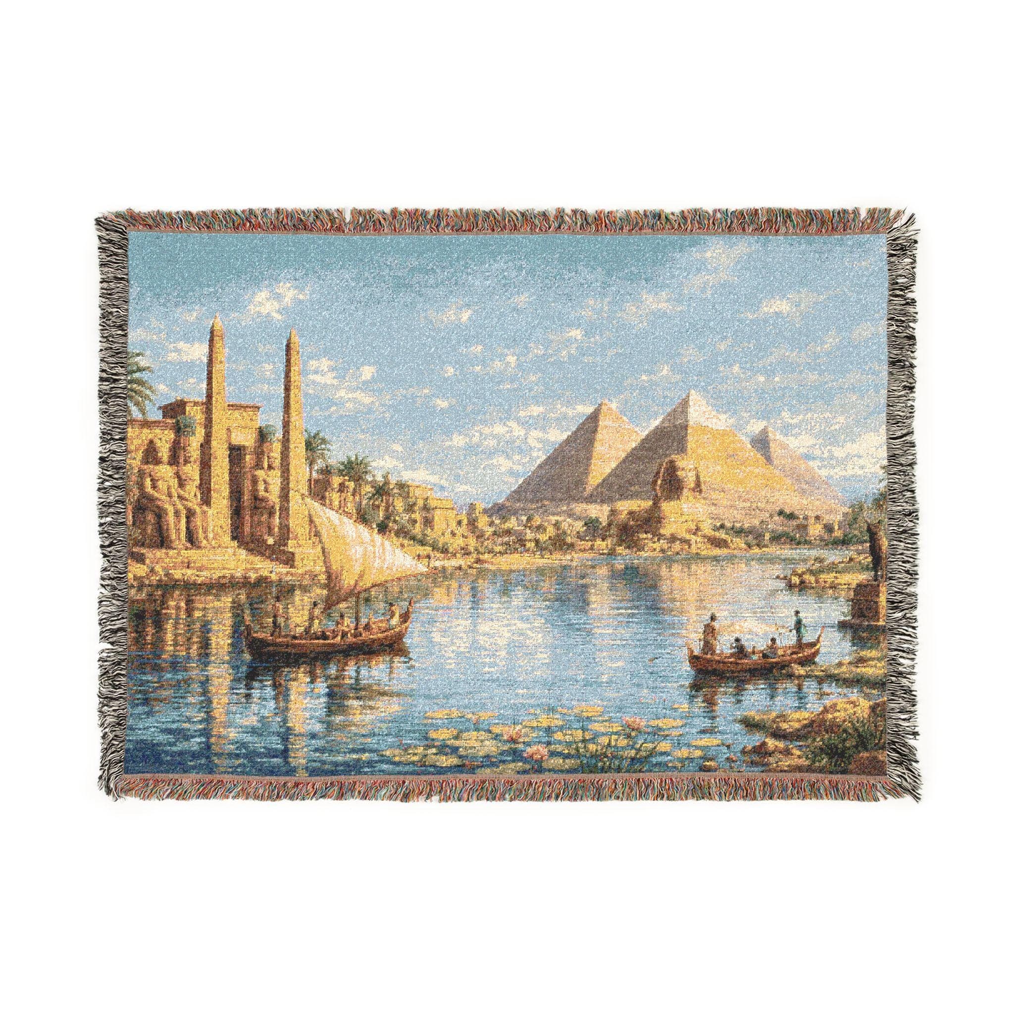 Woven tapestry wall hanging featuring an Ancient Egypt river scene with golden pyramids, a sphinx, obelisks, temple ruins, sailboats drifting across reflective water, and lotus flowers along the shore beneath a bright blue sky. Vintage Egyptian landscape wall art with Nile River scenery, historic architecture, warm desert tones, and old world detail, ideal as a large wall tapestry, woven throw blanket, statement home decor, and gift for history lovers, travelers, and archaeology art collectors.