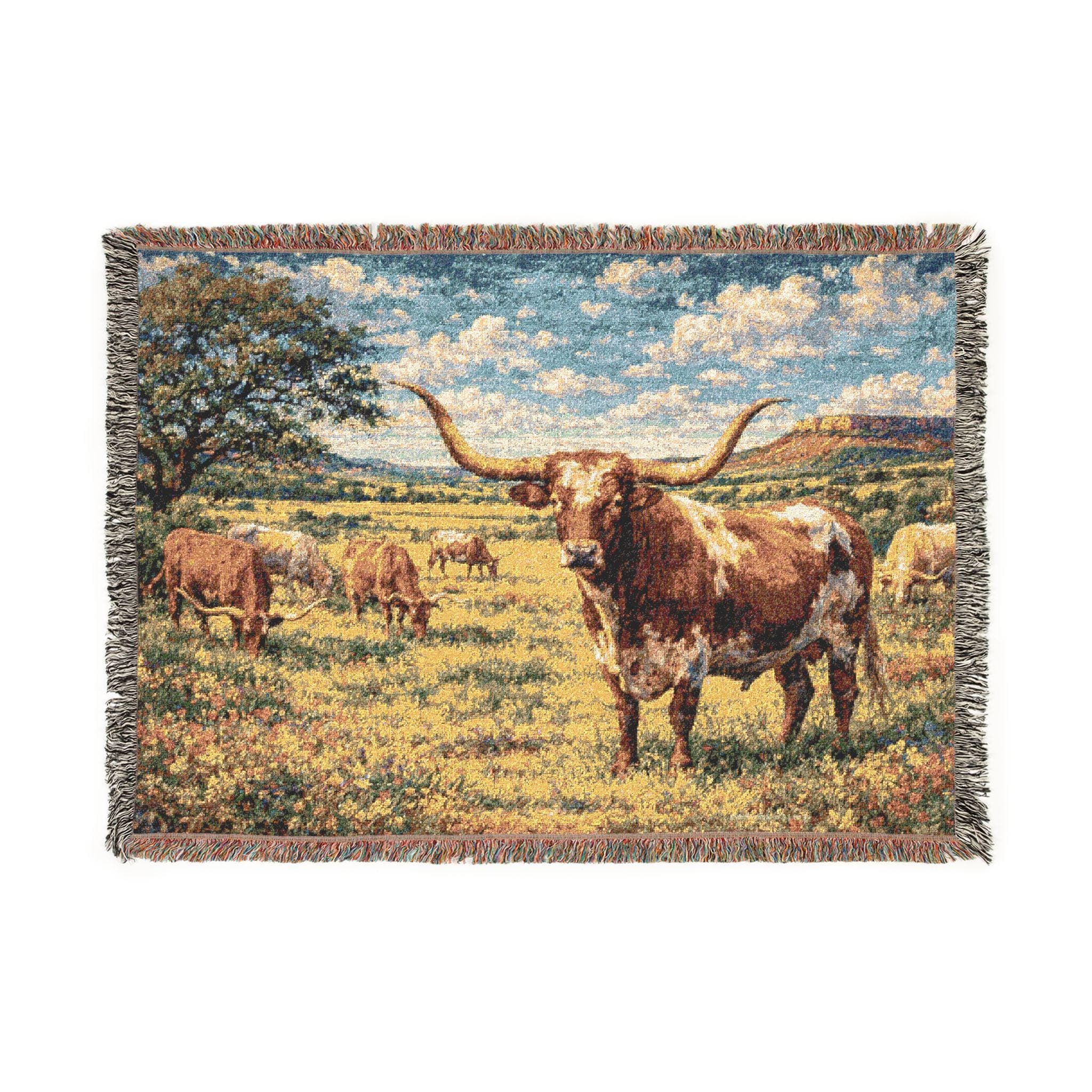 Woven tapestry wall hanging featuring a Texas longhorn standing in a sunny pasture with other cattle grazing across an open ranch field beneath a bright blue sky with soft clouds, a large tree, and distant mesa hills. Western wall art with rustic ranch charm, country farmhouse mood, and warm landscape detail, ideal as a large wall tapestry, decorative throw blanket, lodge room accent, and gift for cow lovers, ranch decor fans, and collectors of Texas inspired home decor.