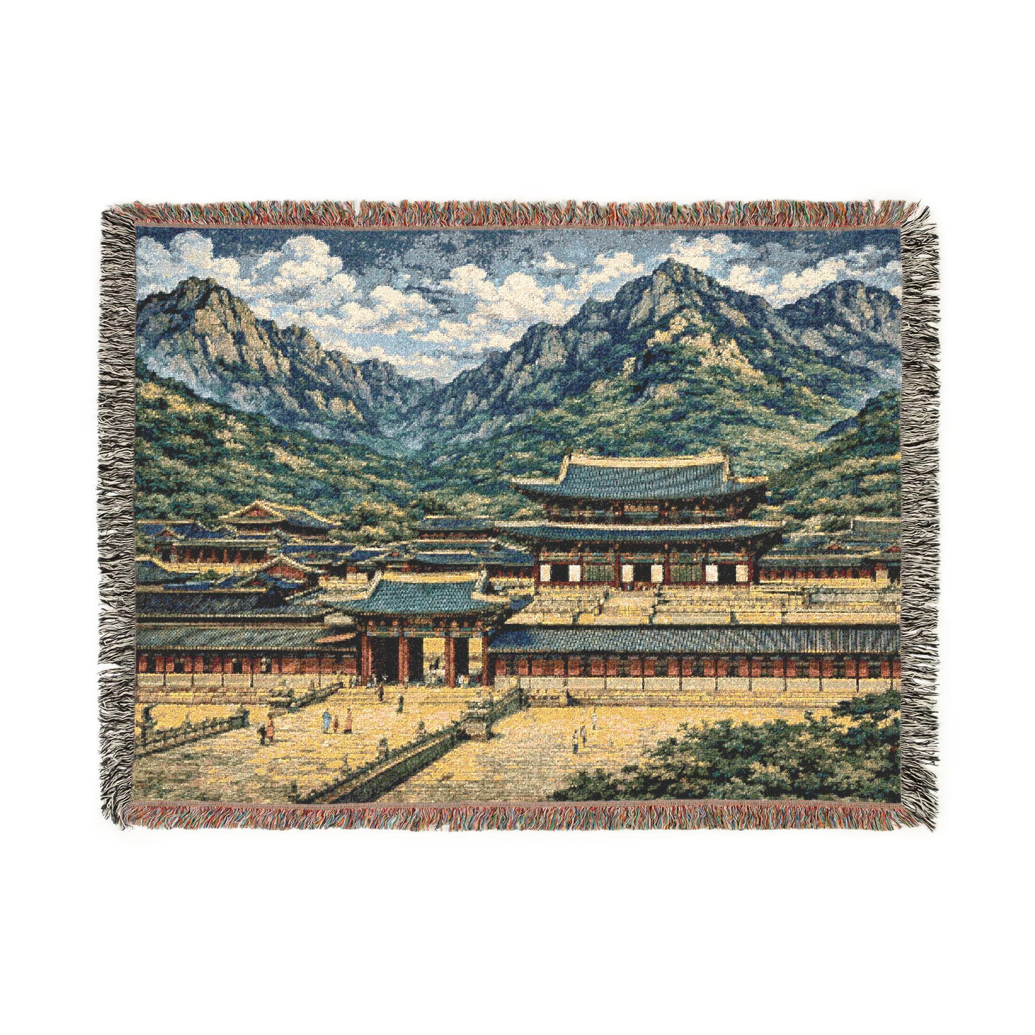 Woven tapestry wall hanging featuring a Korean palace courtyard with layered mountains and soft clouds—traditional Seoul architecture inspired by Gyeongbokgung vibes. Detailed woven texture with fringe edges, perfect as Korean decor, Asian landscape wall hanging, travel souvenir style wall art, and cozy woven throw blanket for couch or bed. Ideal gift for Korea lovers, history buffs, K-drama fans, and architecture enthusiasts.