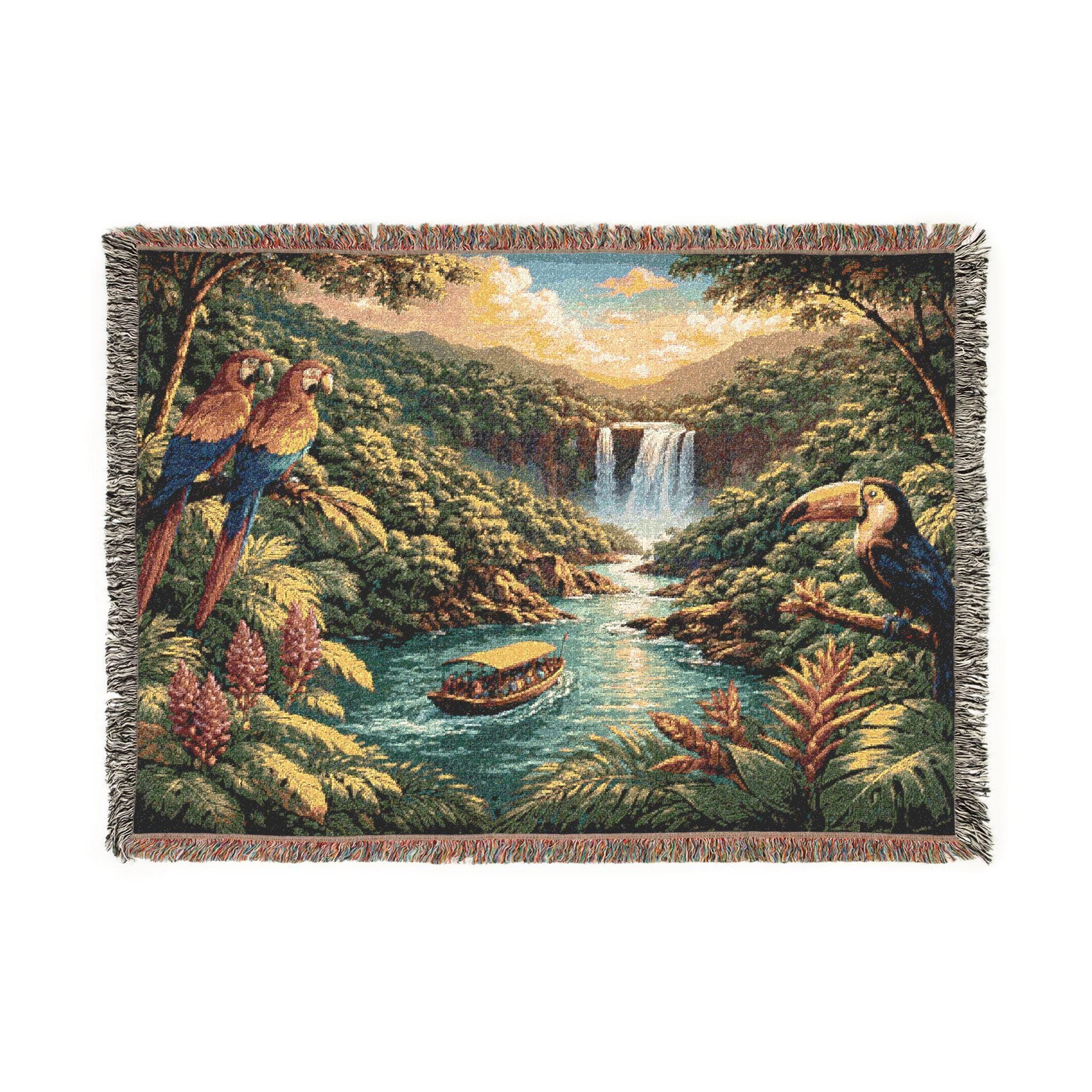Woven tapestry blanket showing a tropical rainforest landscape with a waterfall in the distance, river flowing through lush green jungle, and a small boat cruising on the water. Colorful parrots perched on the left and a toucan on the right add vibrant wildlife detail. Textured woven look with fringed edges for tapestry wall art, jungle wall decor, coastal tropical home accent, bedroom or living room statement piece. Great gift for nature lovers and bird lovers.