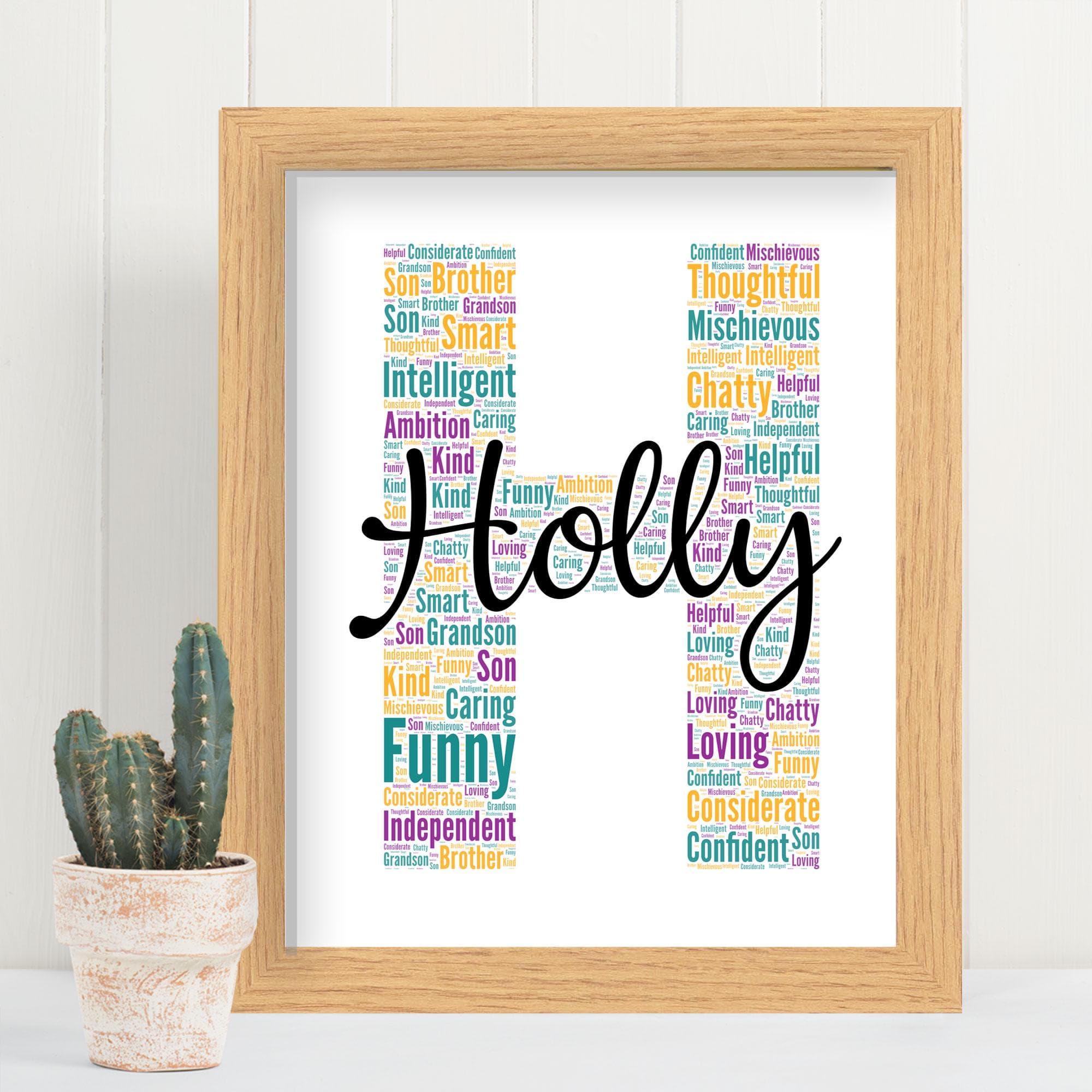 Personalised initial silhouette wall art created from custom words and names, displayed in a modern white wooden frame on a colourful nursery wall